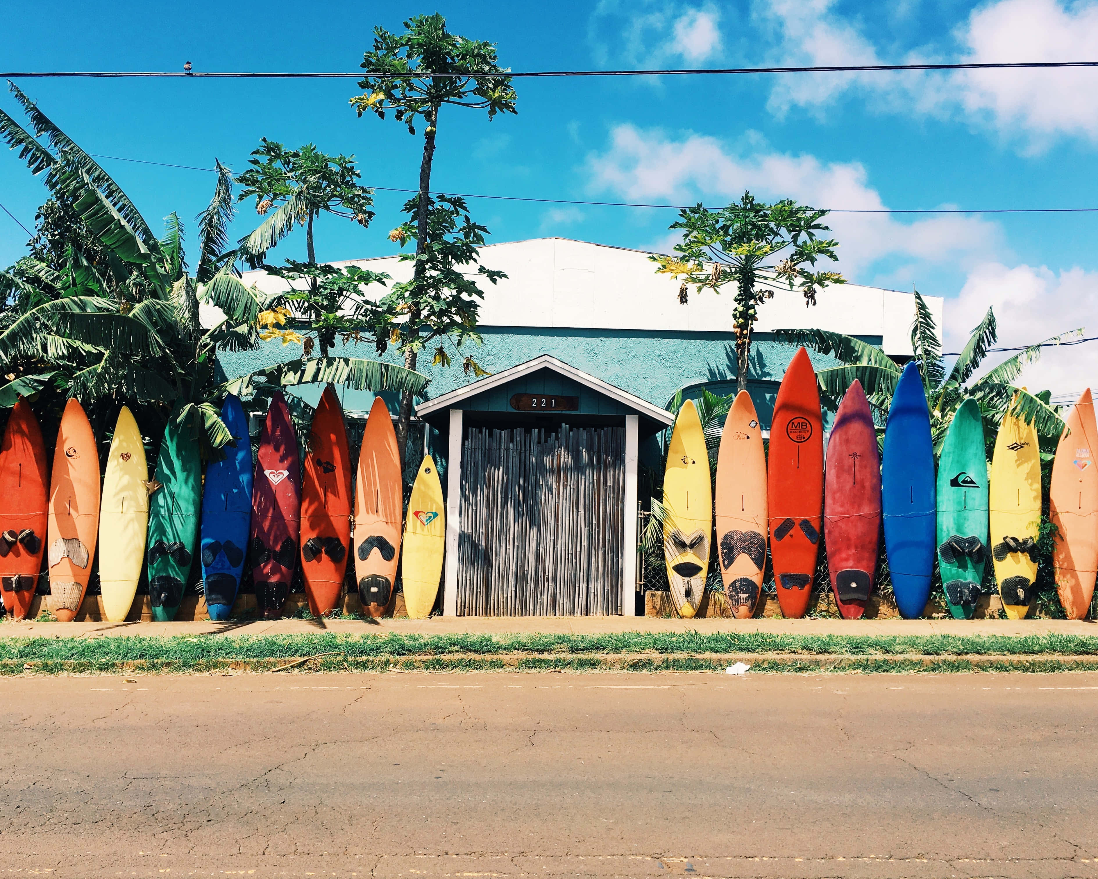 colorful surfboard, rainbow hues, rustic shed, 2K Desktop Wallpaper
