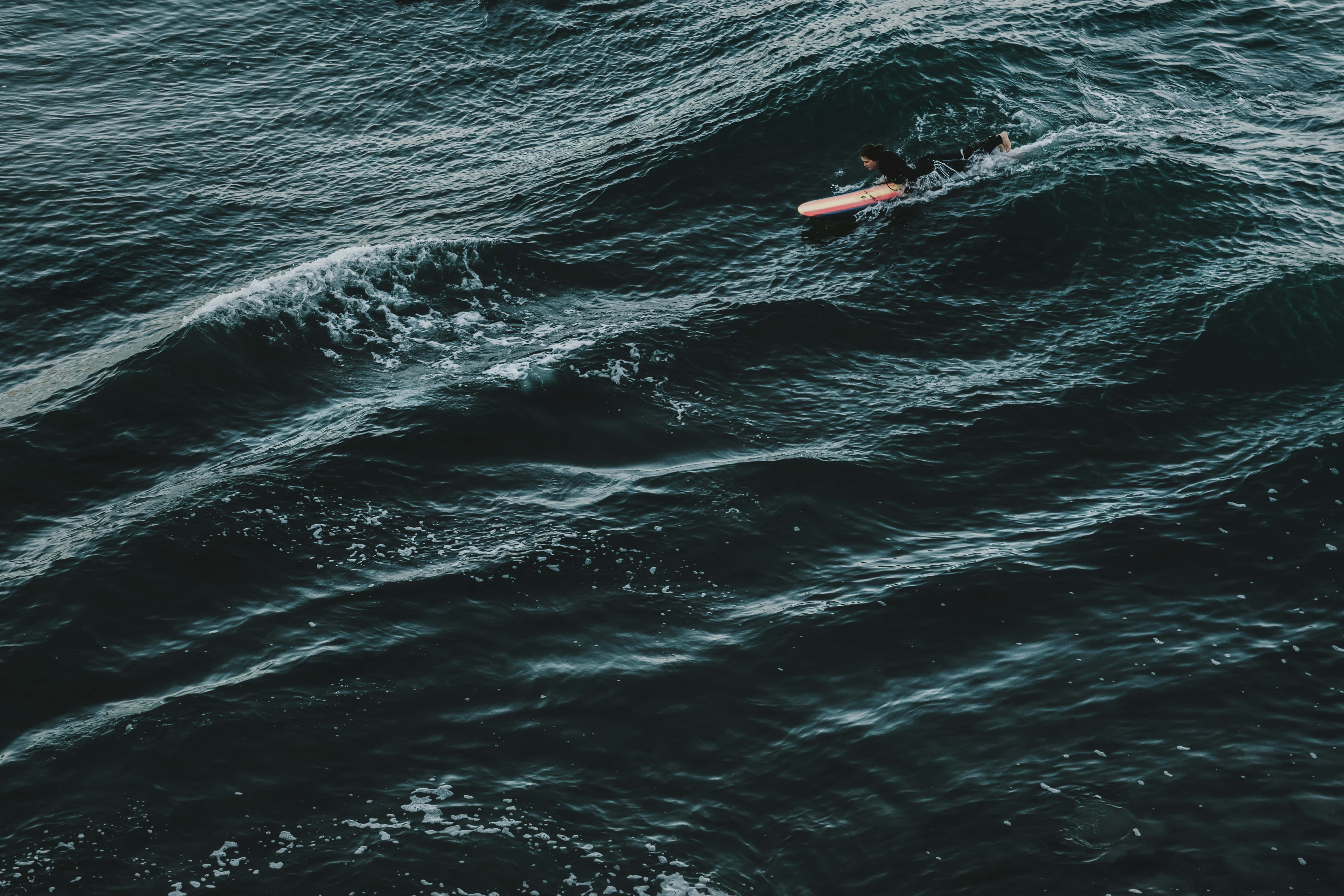 pink board, dark teal ocean waves, aerial view, 5K Desktop Wallpaper