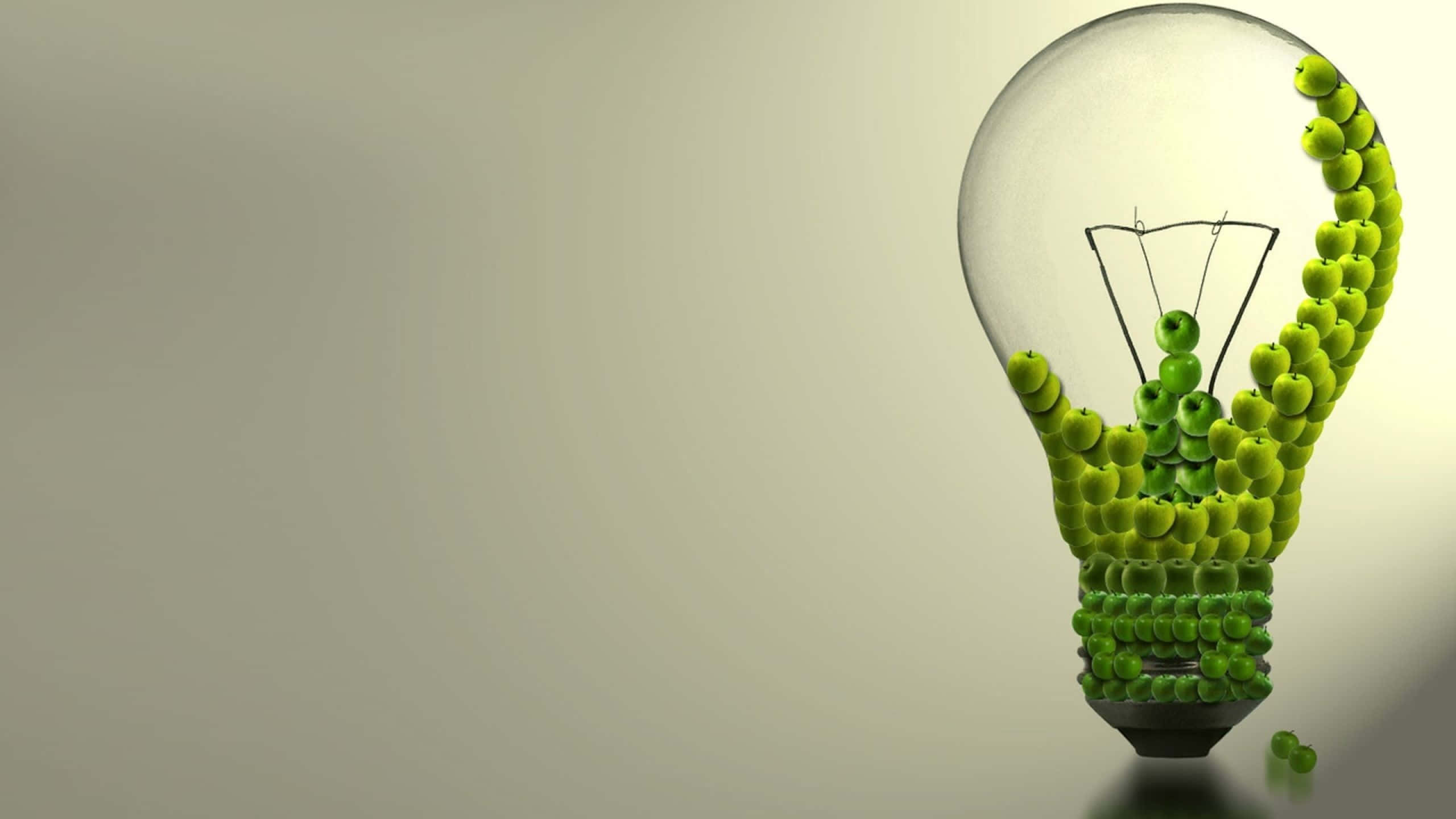 Sustainability Light Bulb, green apples, glowing filament, 2K Desktop Wallpaper