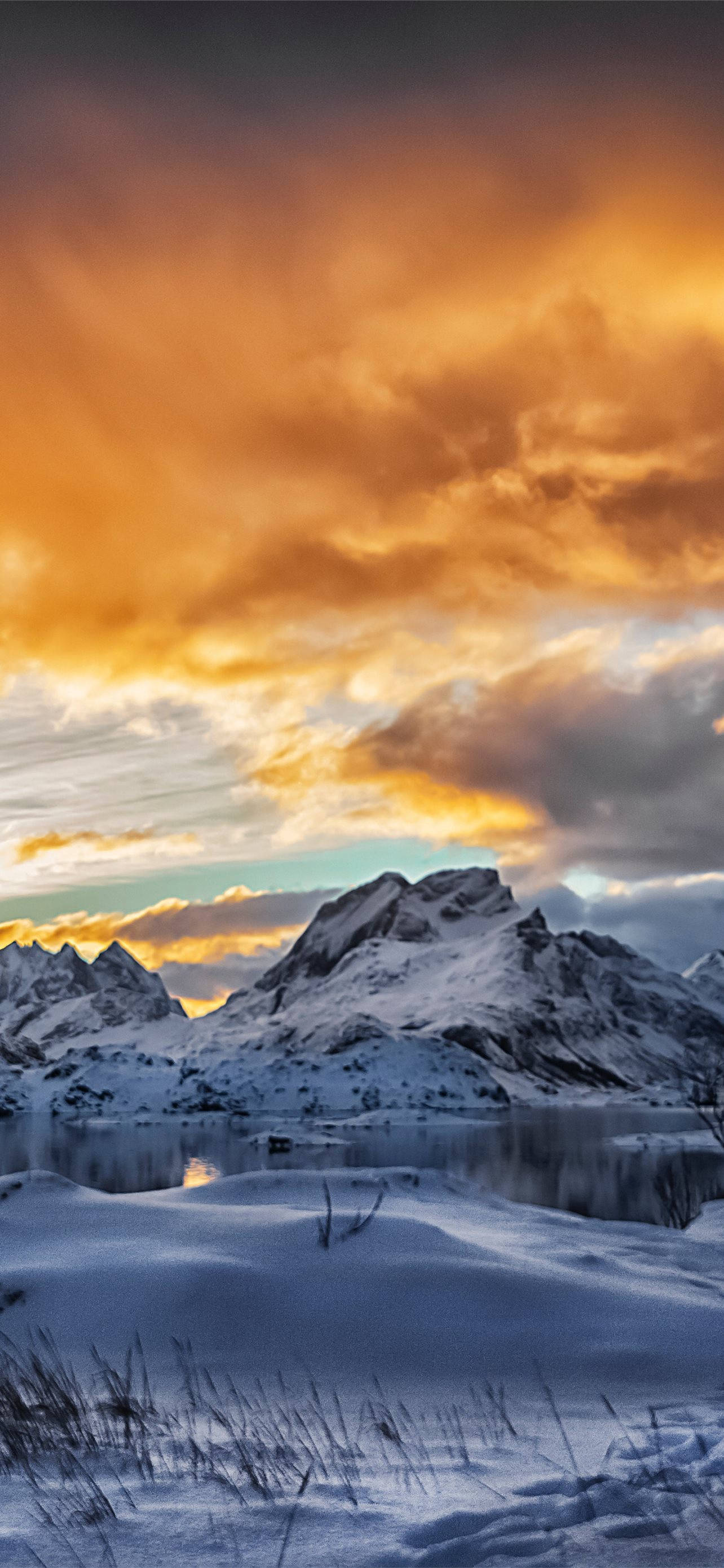 Svalbard, rusty orange clouds, snowy mountain peaks, 2K Phone Wallpaper