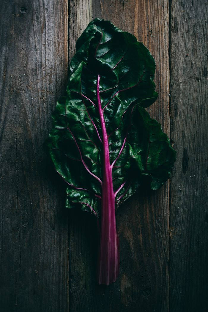 Swiss Chard, dark toned wooden table, vibrant chard leaf, SD Phone Wallpaper