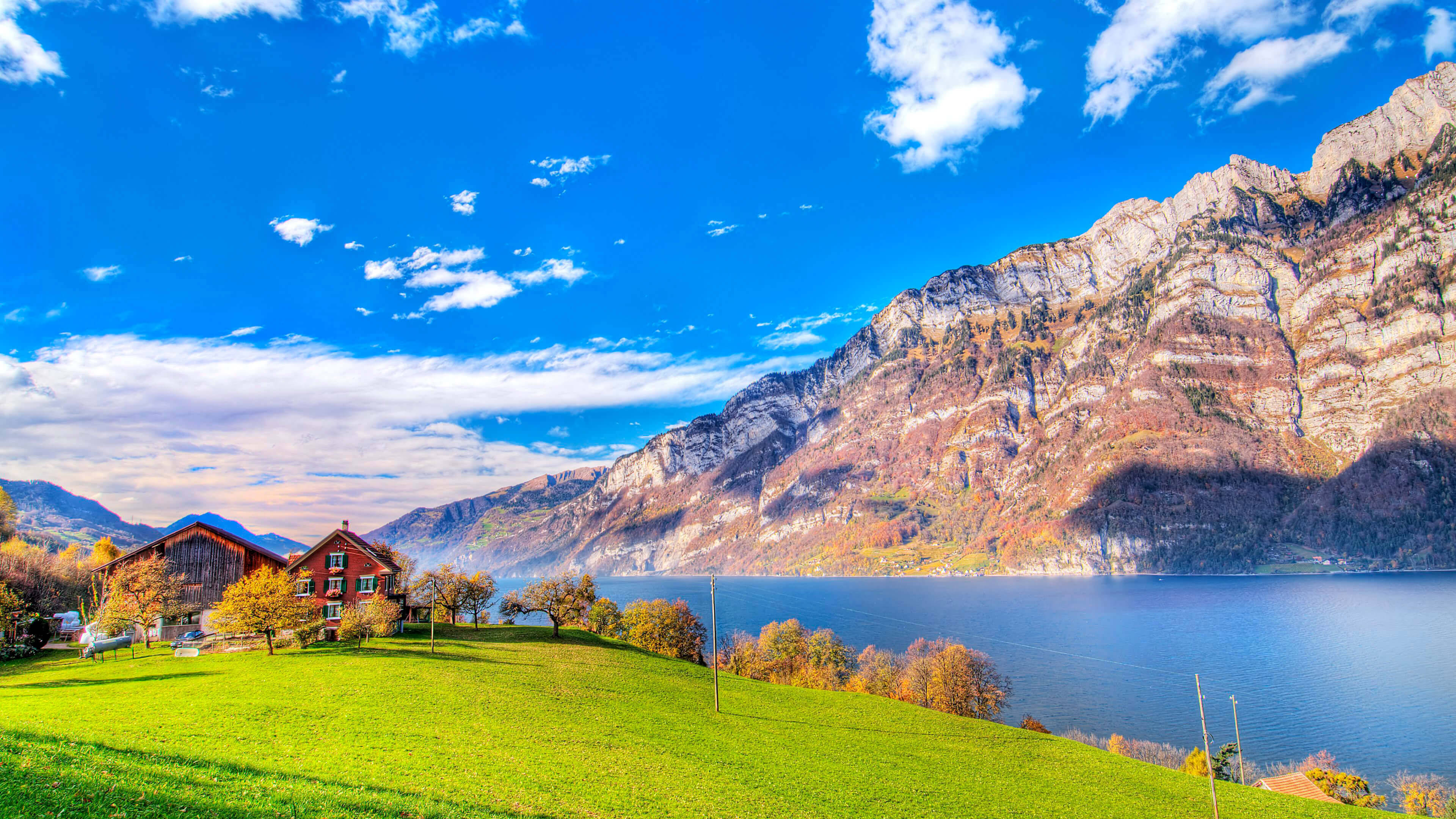 Switzerland, red chalet, sunlit green hillside, 4K Desktop Wallpaper