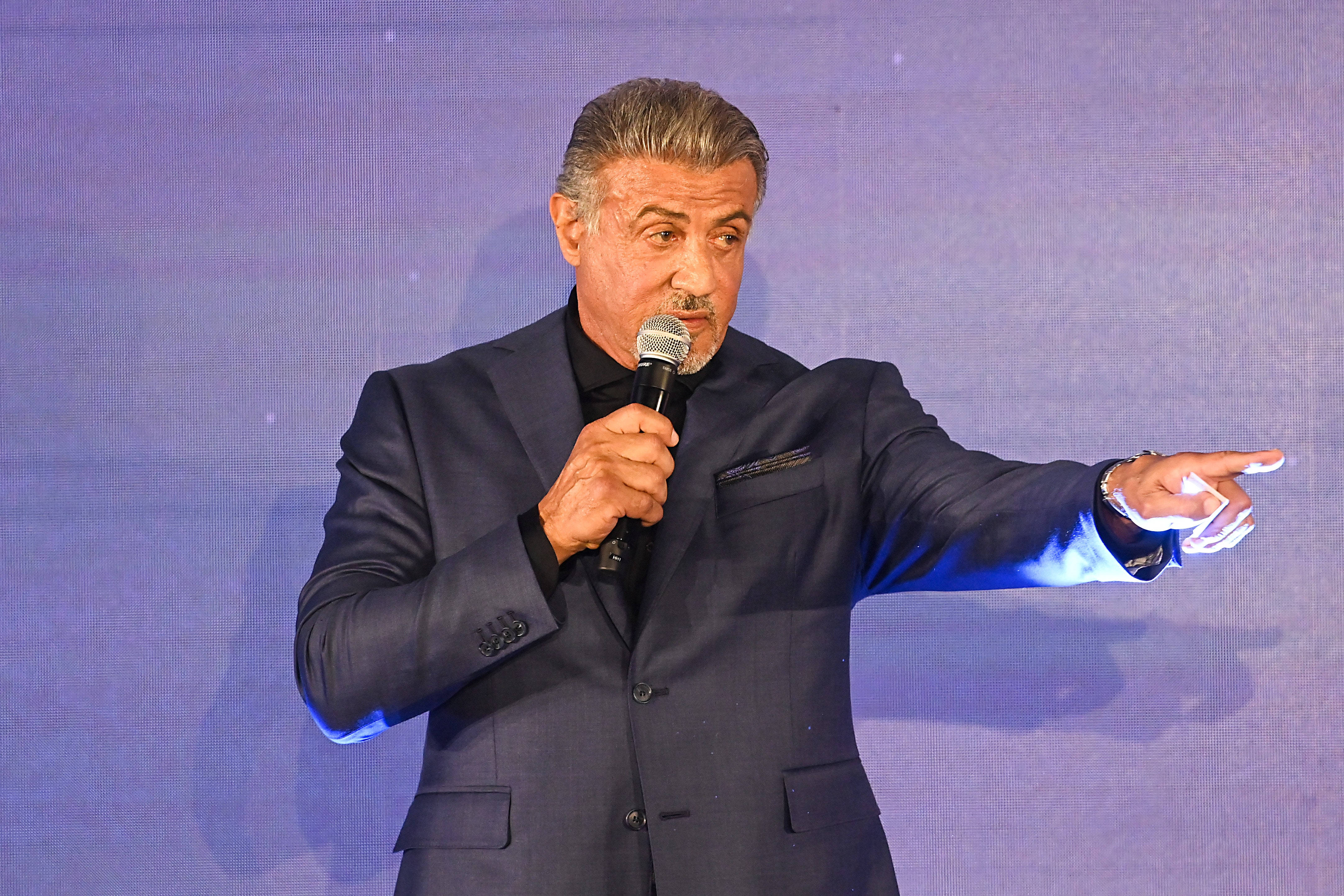 Sylvester Stallone, microphone, blue-lit stage, 4K Desktop Wallpaper