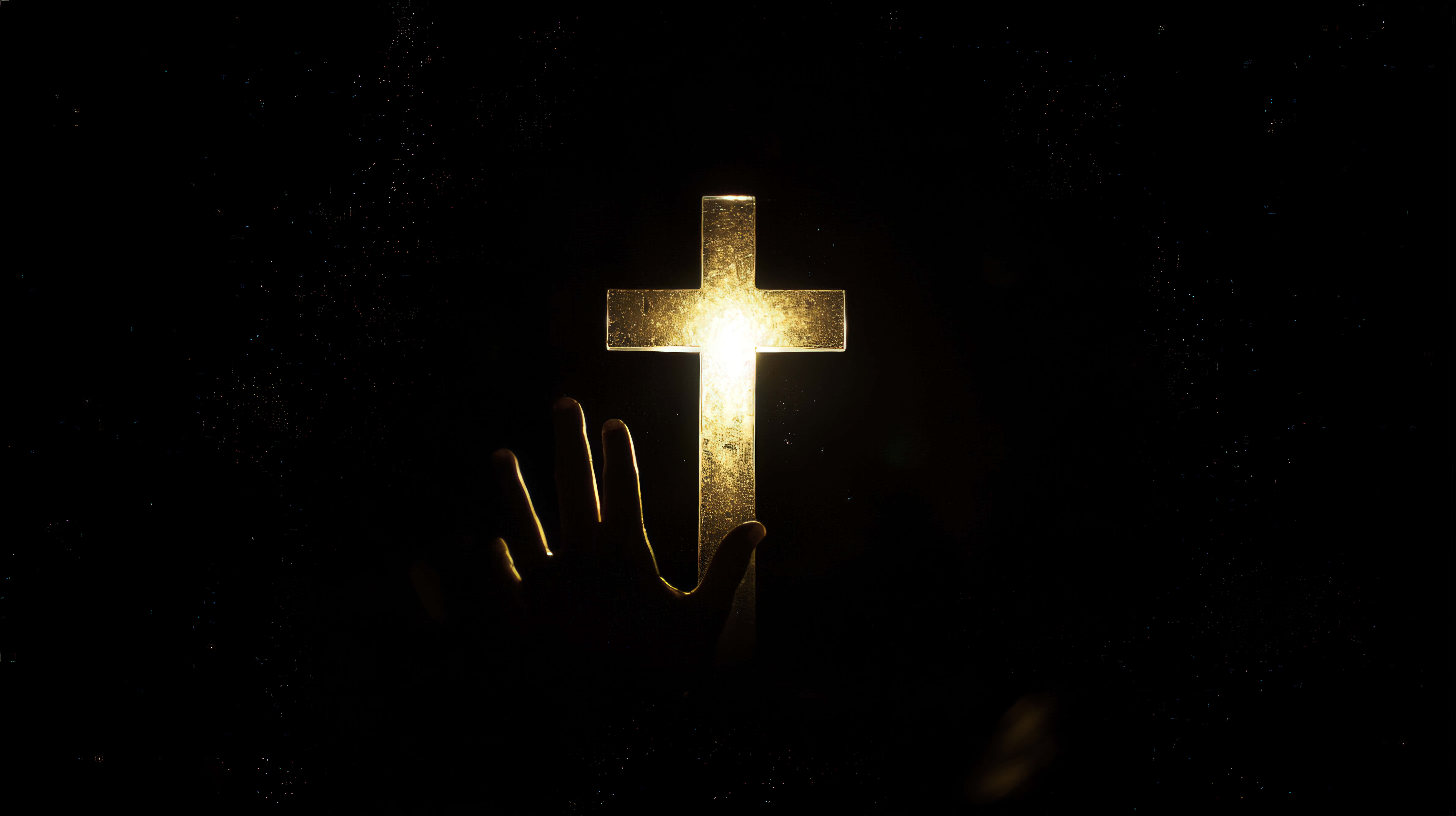 glowing golden cross, hand reaching toward, dark speckled background, 8K Desktop Wallpaper