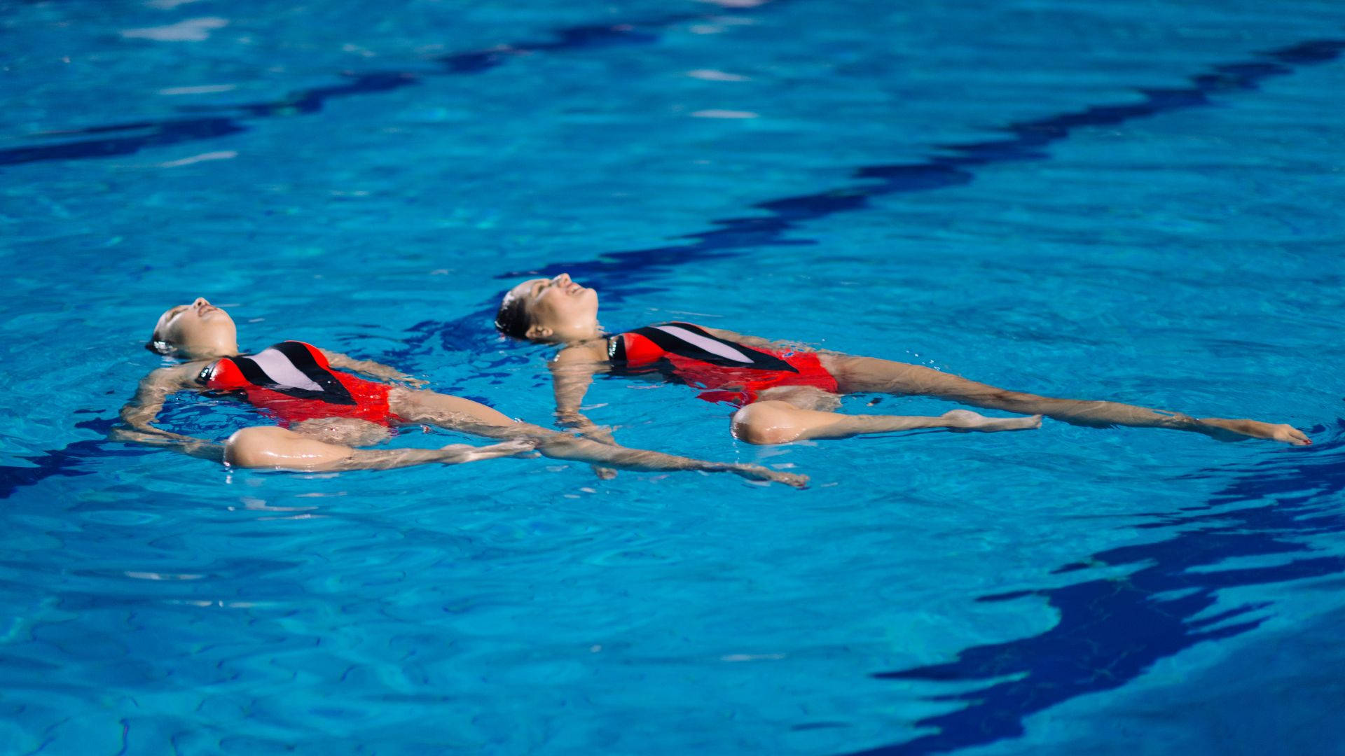 artistic swimming, red and black suits, vibrant blue pool water, Full HD Desktop Wallpaper