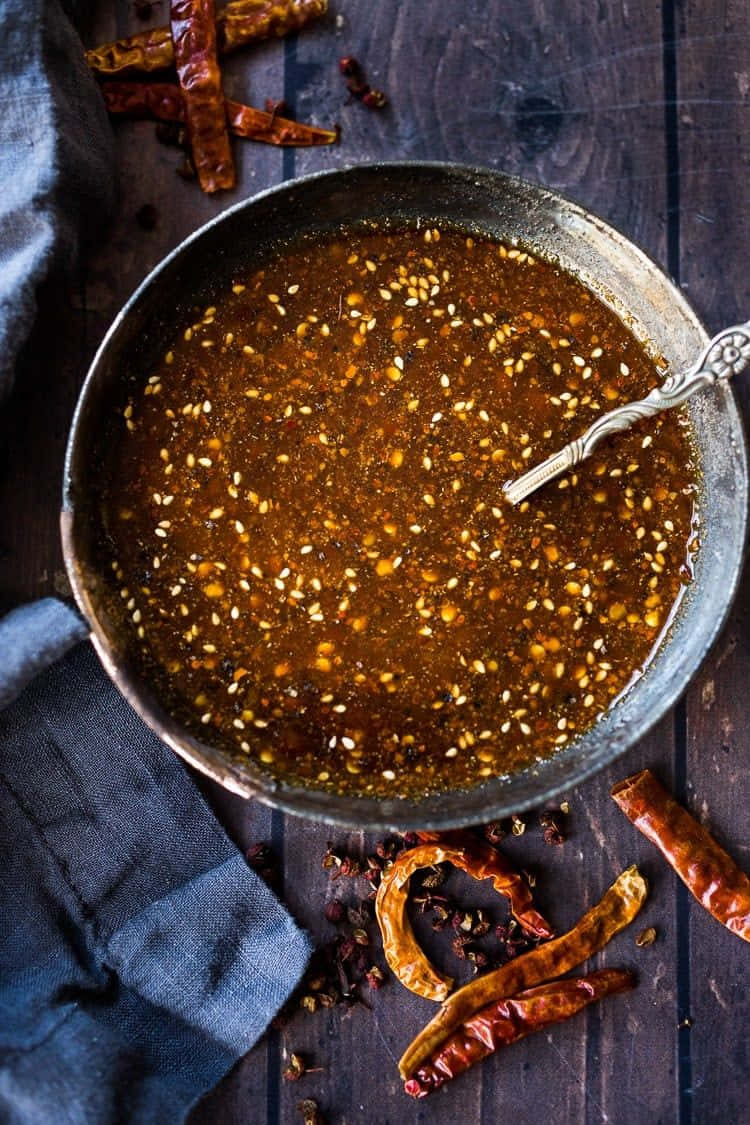 Szechuan sauce, rustic metal bowl, dark wooden table, SD Phone Wallpaper