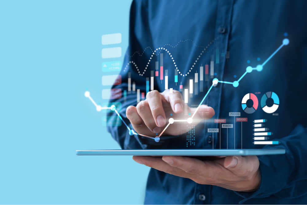 tablet, glowing holographic financial charts and graphs, dark shirt, SD Desktop Wallpaper