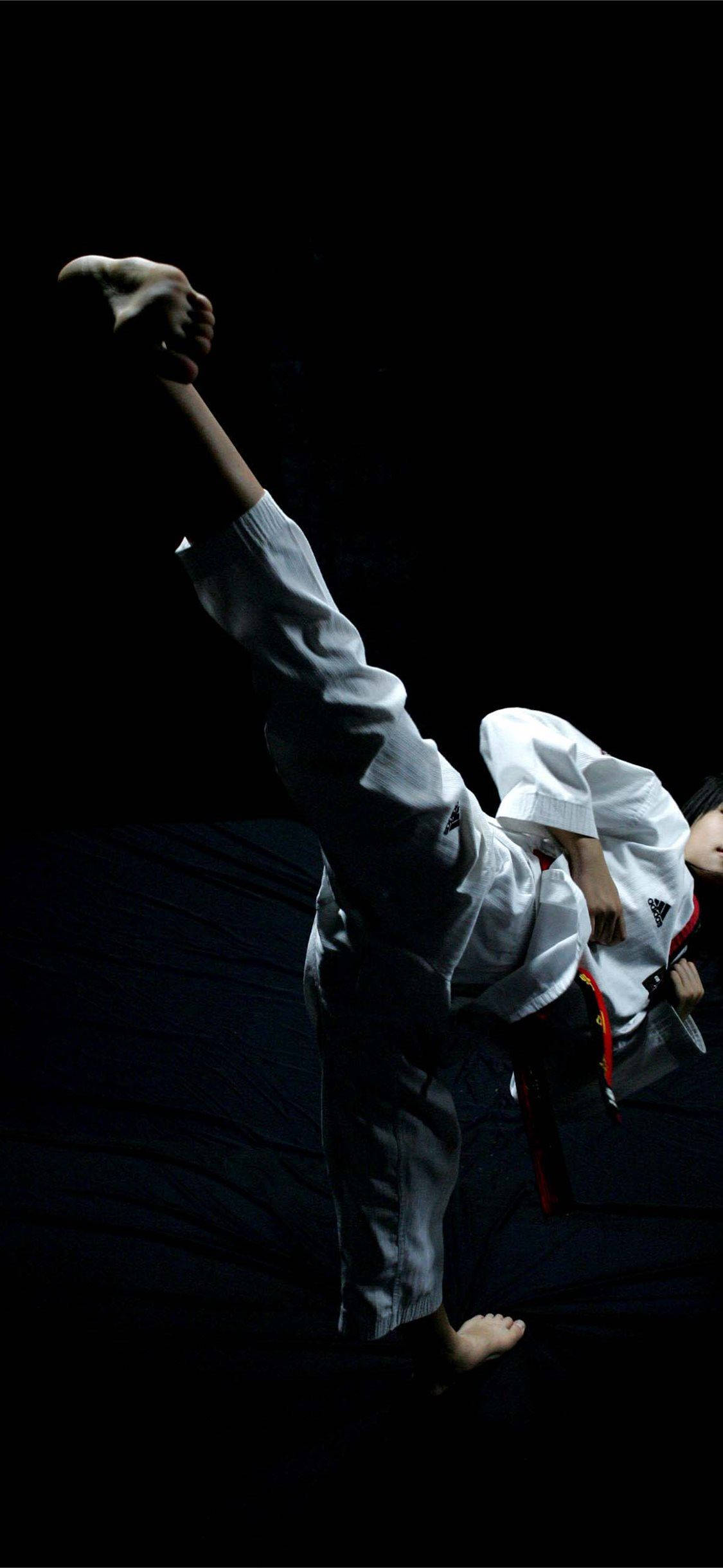 white gi, high kick, stark black background, Full HD Phone Wallpaper