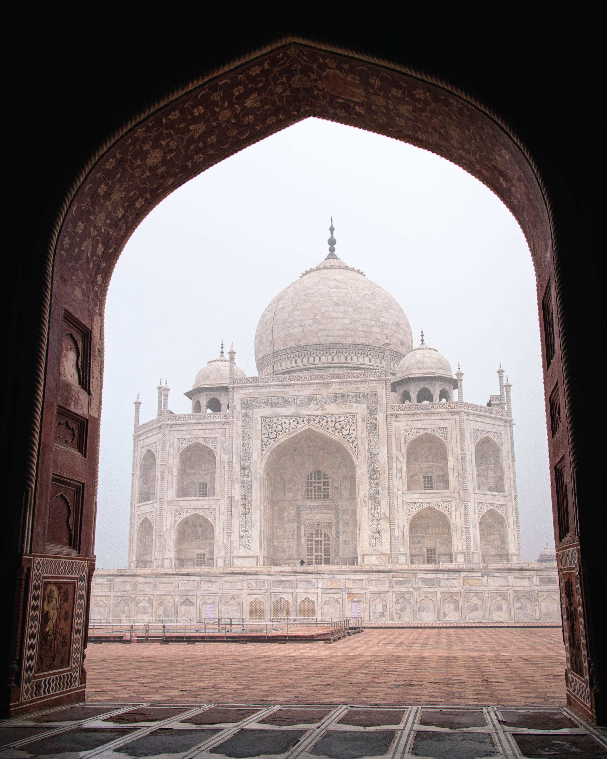 Taj Mahal, ornate arched doorway, hazy sky, 2K Phone Wallpaper