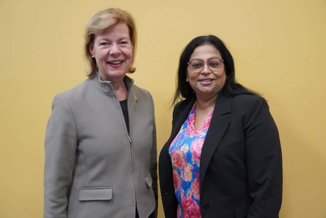 Tammy Baldwin, gray coat, yellow wall, SD Desktop Wallpaper