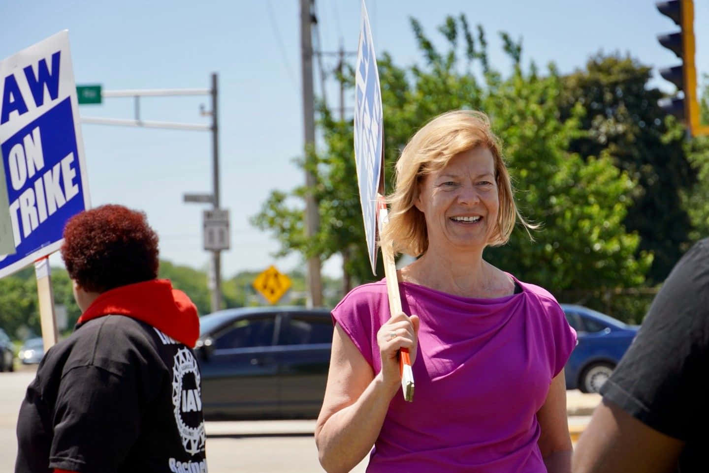 Tammy Baldwin, purple shirt, protest sign, HD Desktop Wallpaper