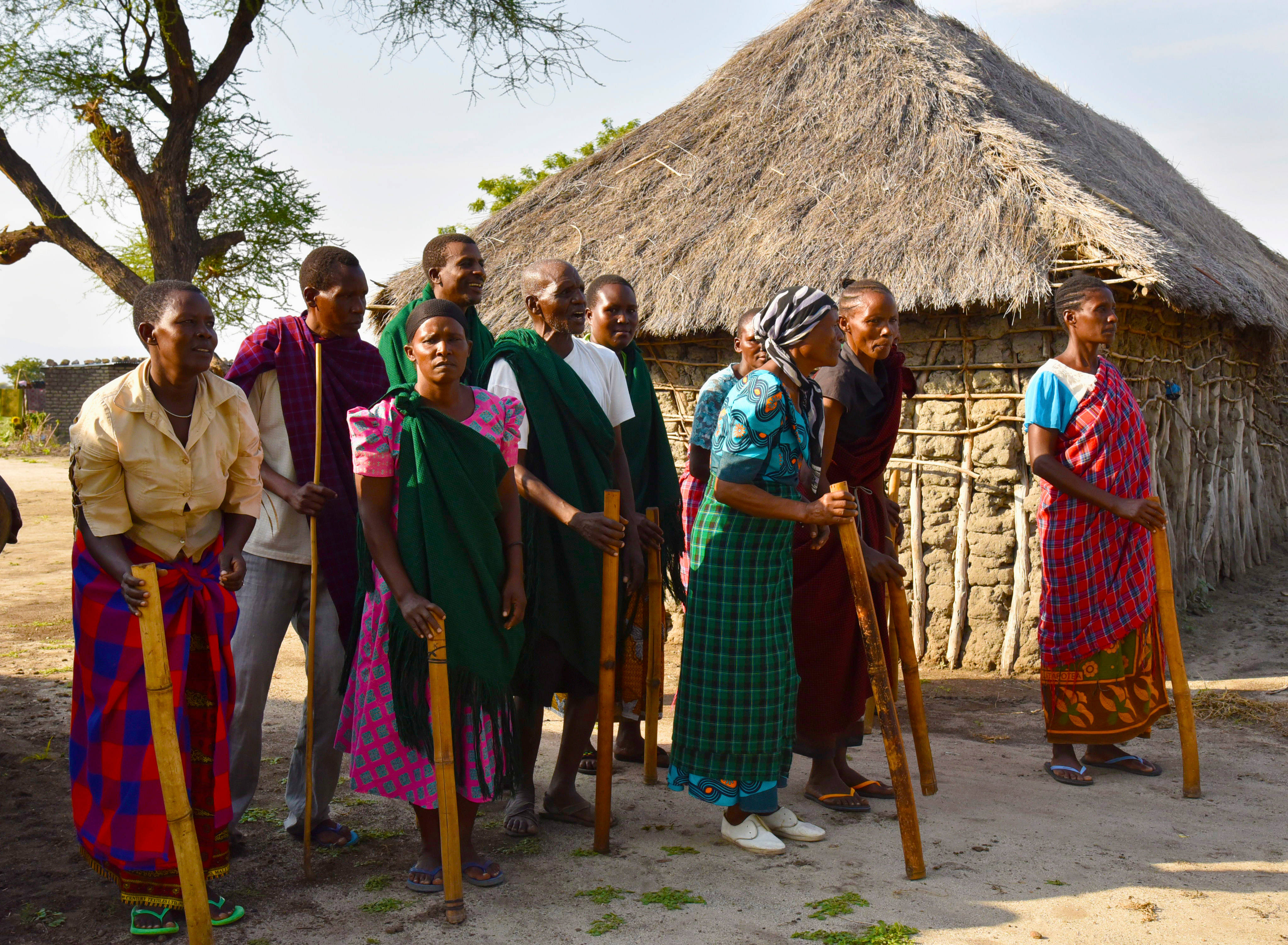 Local Tanzanian People, colorful traditional attire, wooden sticks, 4K Desktop Wallpaper