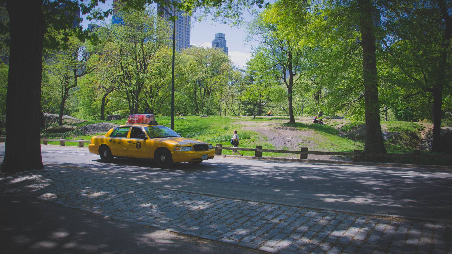 yellow taxi, tree-lined cobblestone path, lush green urban park, Full HD Desktop Wallpaper