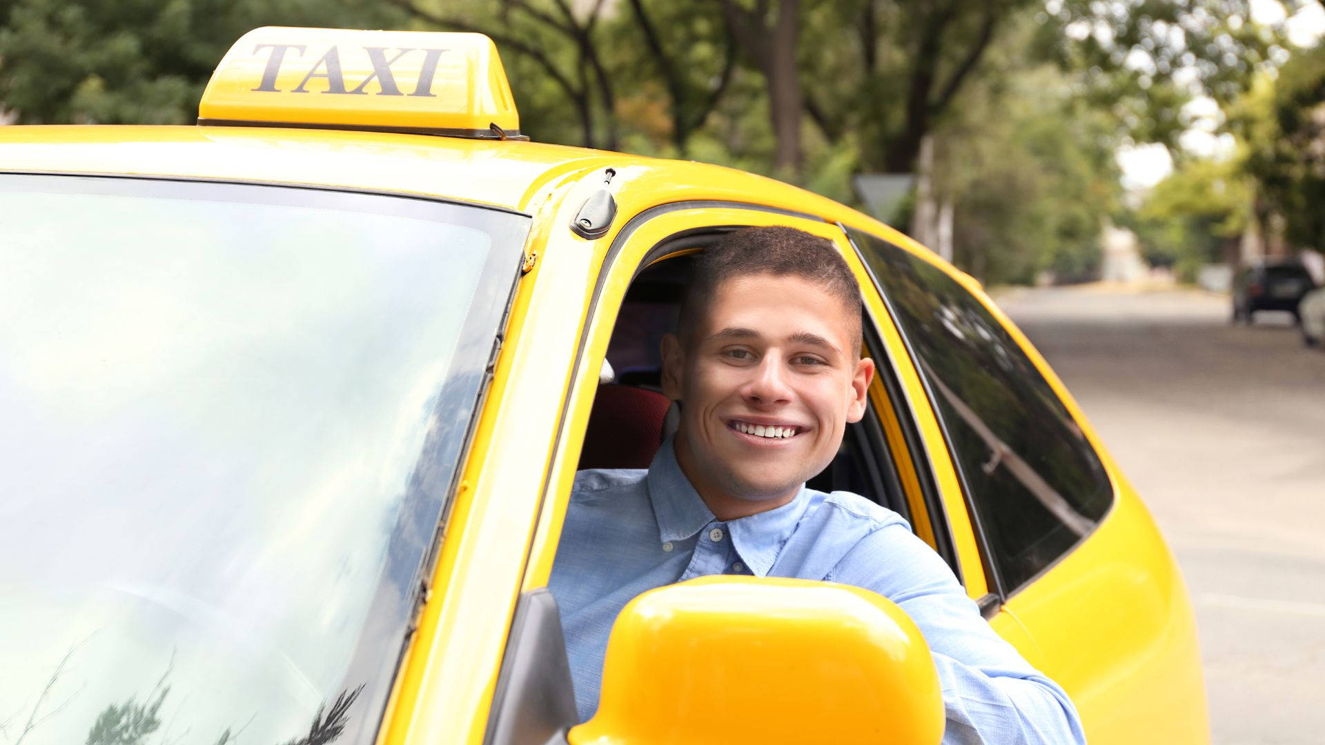 bright yellow taxi, smiling male taxi driver, tree-lined street, Full HD Desktop Wallpaper