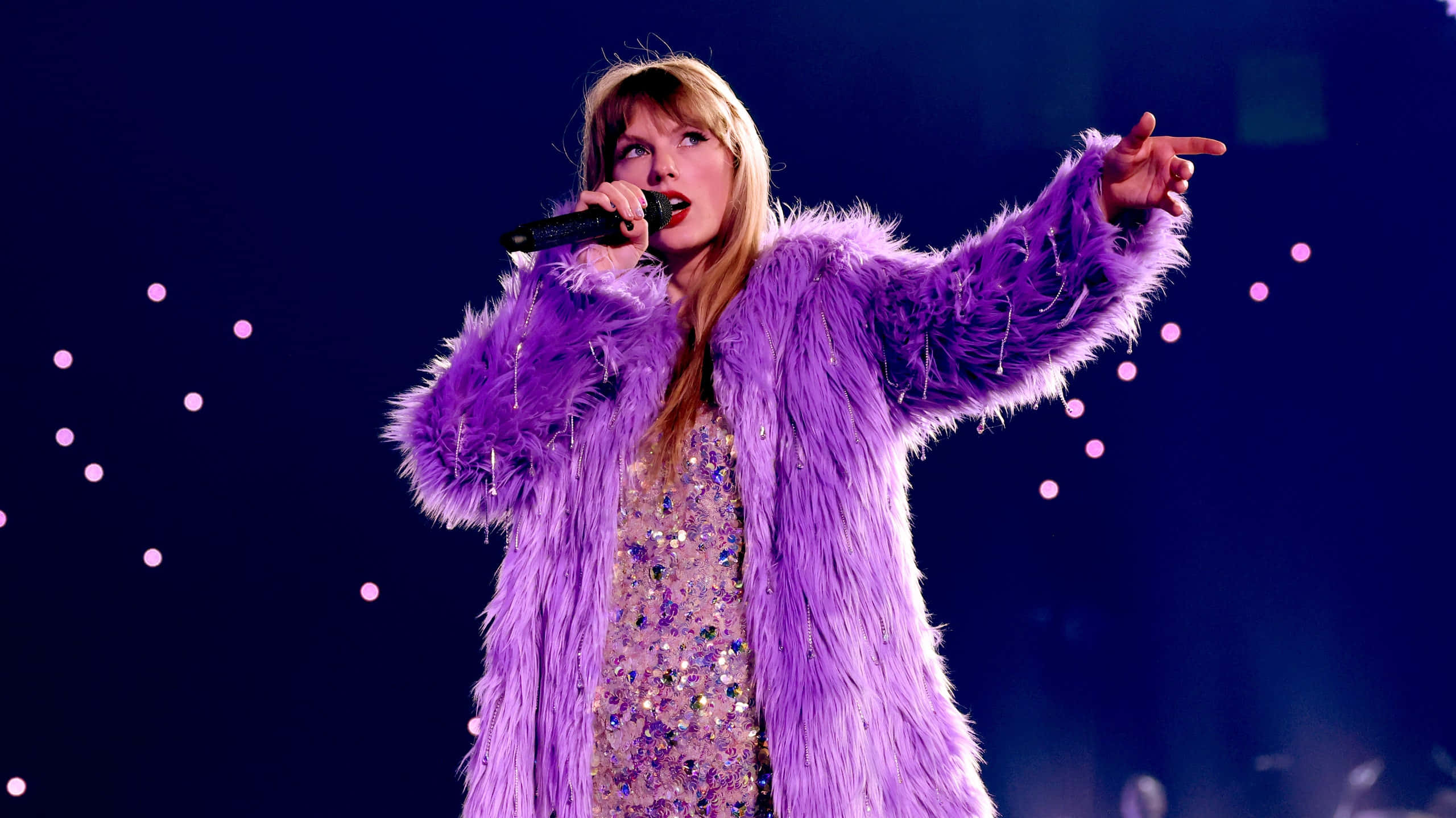 Taylor Swift Eras Tour, sparkling purple fur coat, vibrant stage lights, 2K Desktop Wallpaper