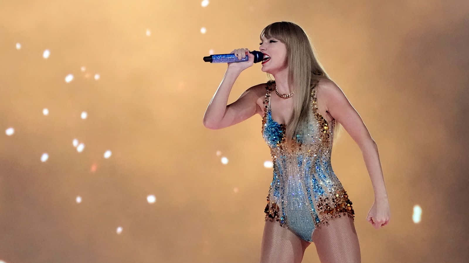 Taylor Swift, sparkling blue and gold bodysuit, warm stage lights, HD Desktop Wallpaper