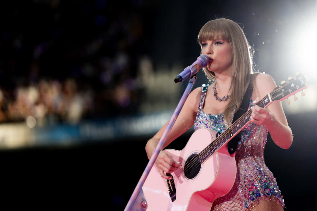 Taylor Swift, pink acoustic guitar, bright stage lights, SD Desktop Wallpaper