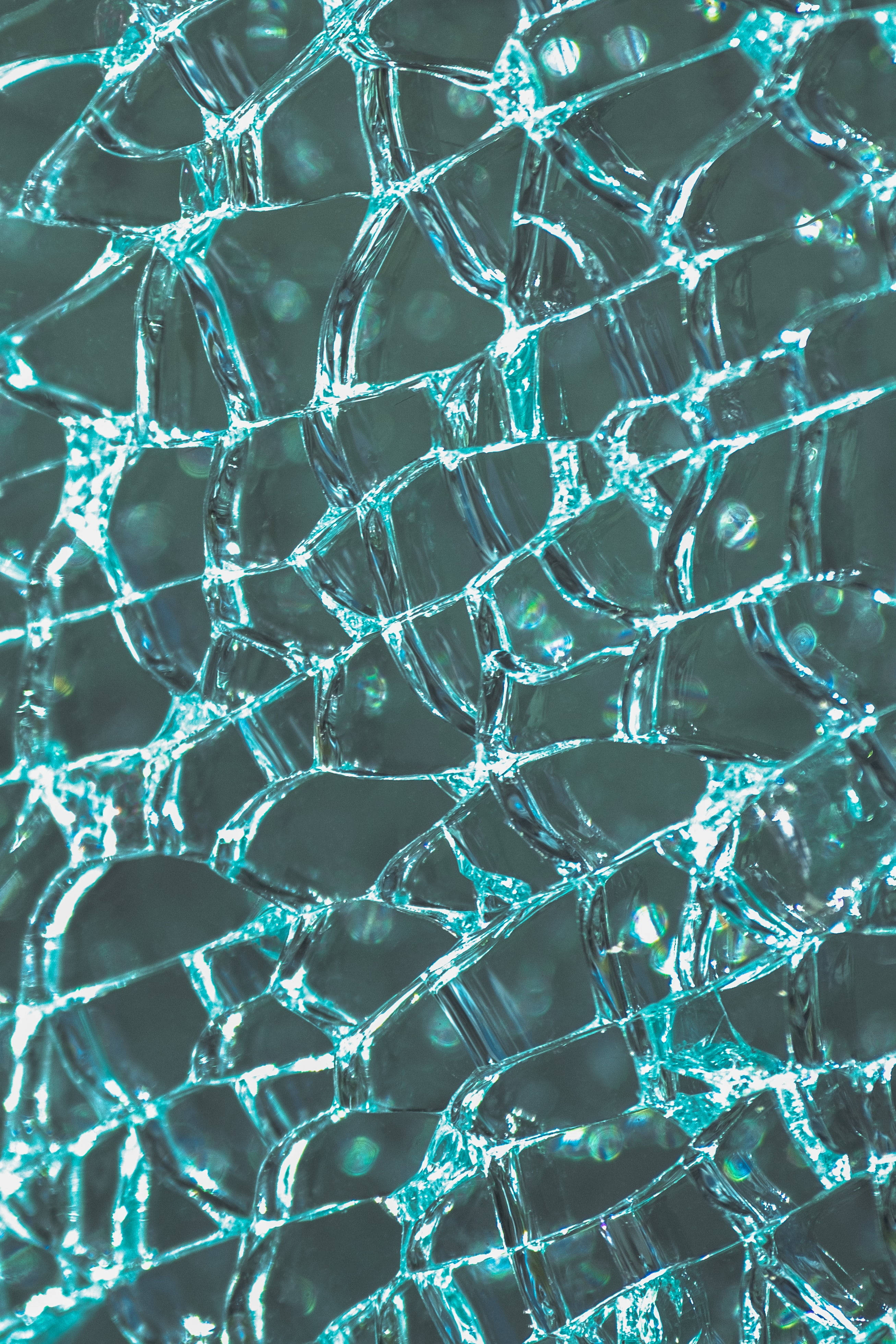 broken glass pieces, glowing turquoise, dark background, 4K Phone Wallpaper