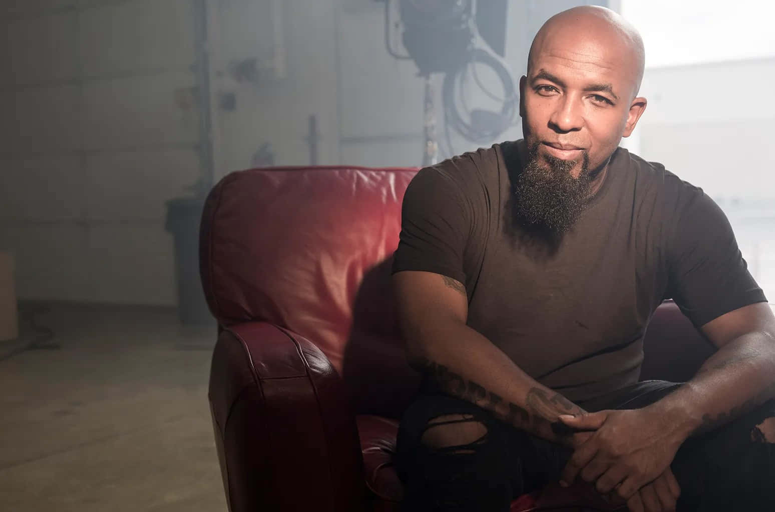 Tech n9ne, red leather chair, dimly lit industrial space, HD Desktop Wallpaper