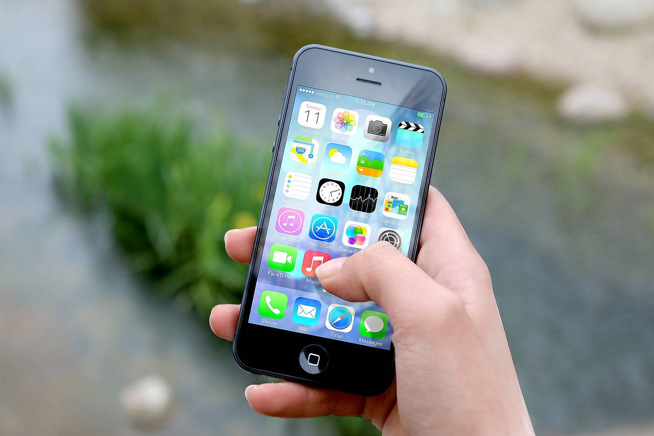 iPhone, colorful app icons, blurred natural water and greenery background, HD Desktop Wallpaper