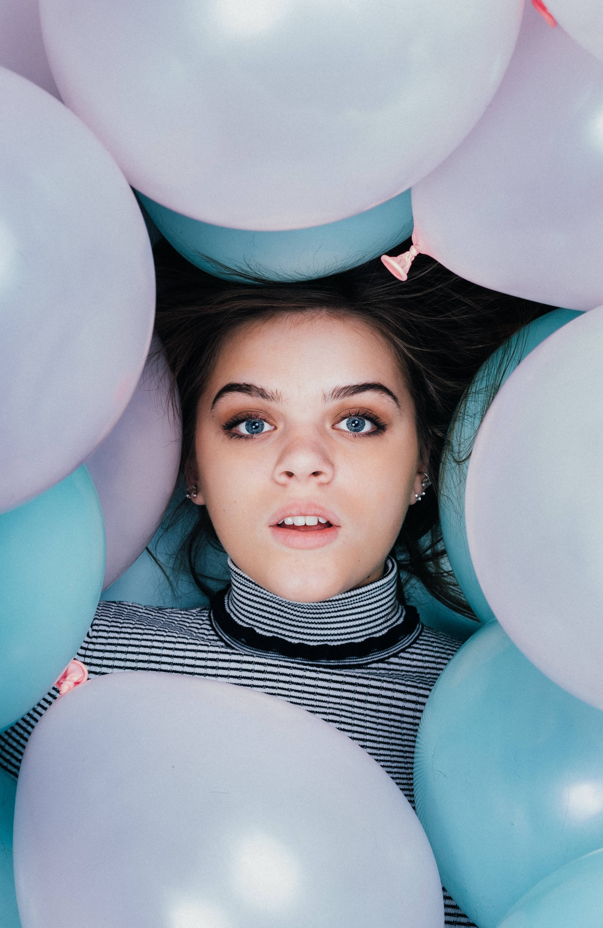 beautiful teenage girl, pastel blue and white balloons, striking blue eyes, 2K Phone Wallpaper
