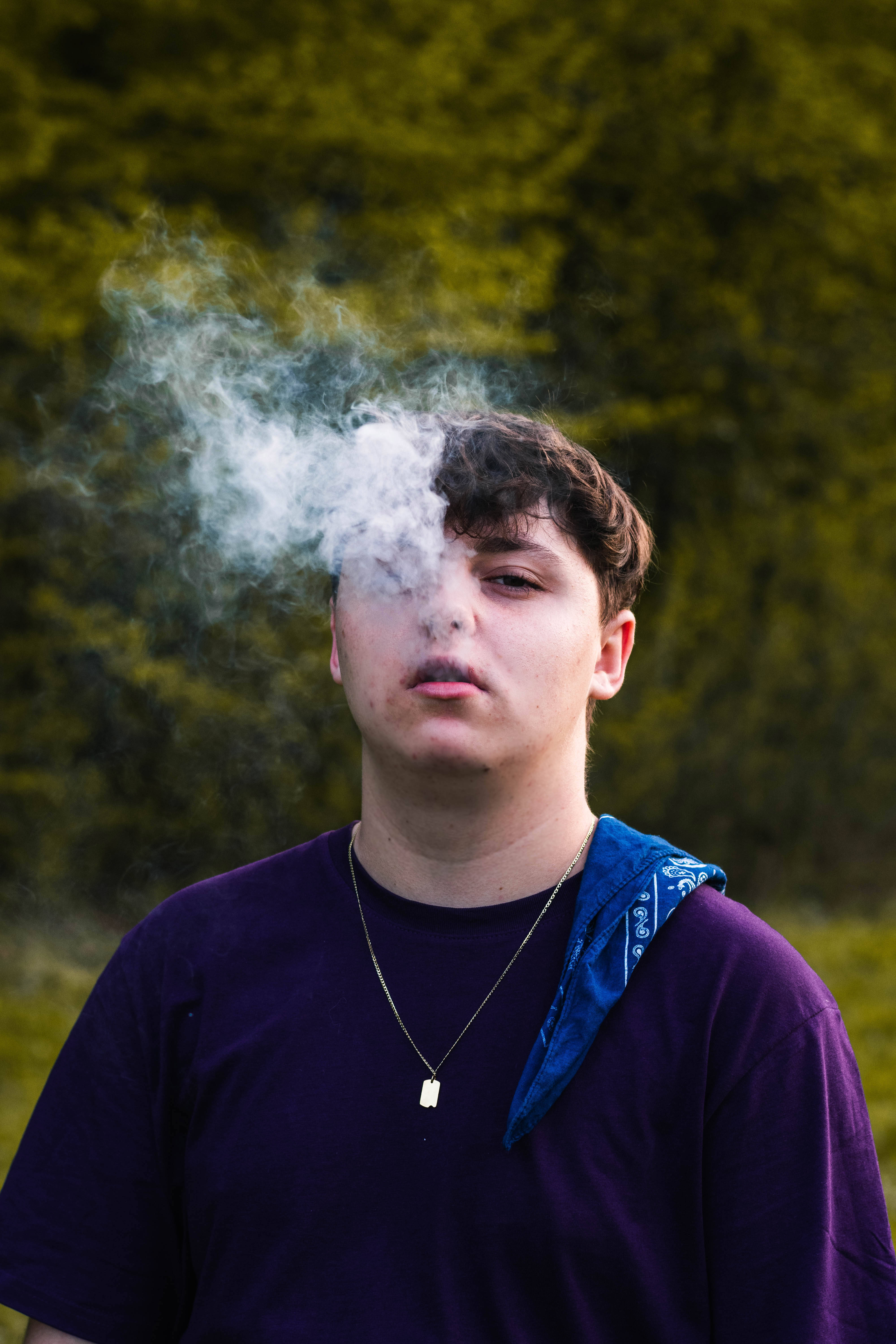 purple shirt, smoke, blurred green forest, 5K Phone Wallpaper