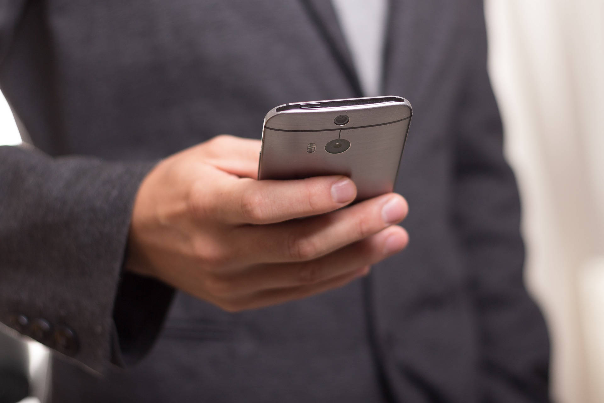 silver smartphone, dark suit, close-up, Full HD Desktop Wallpaper