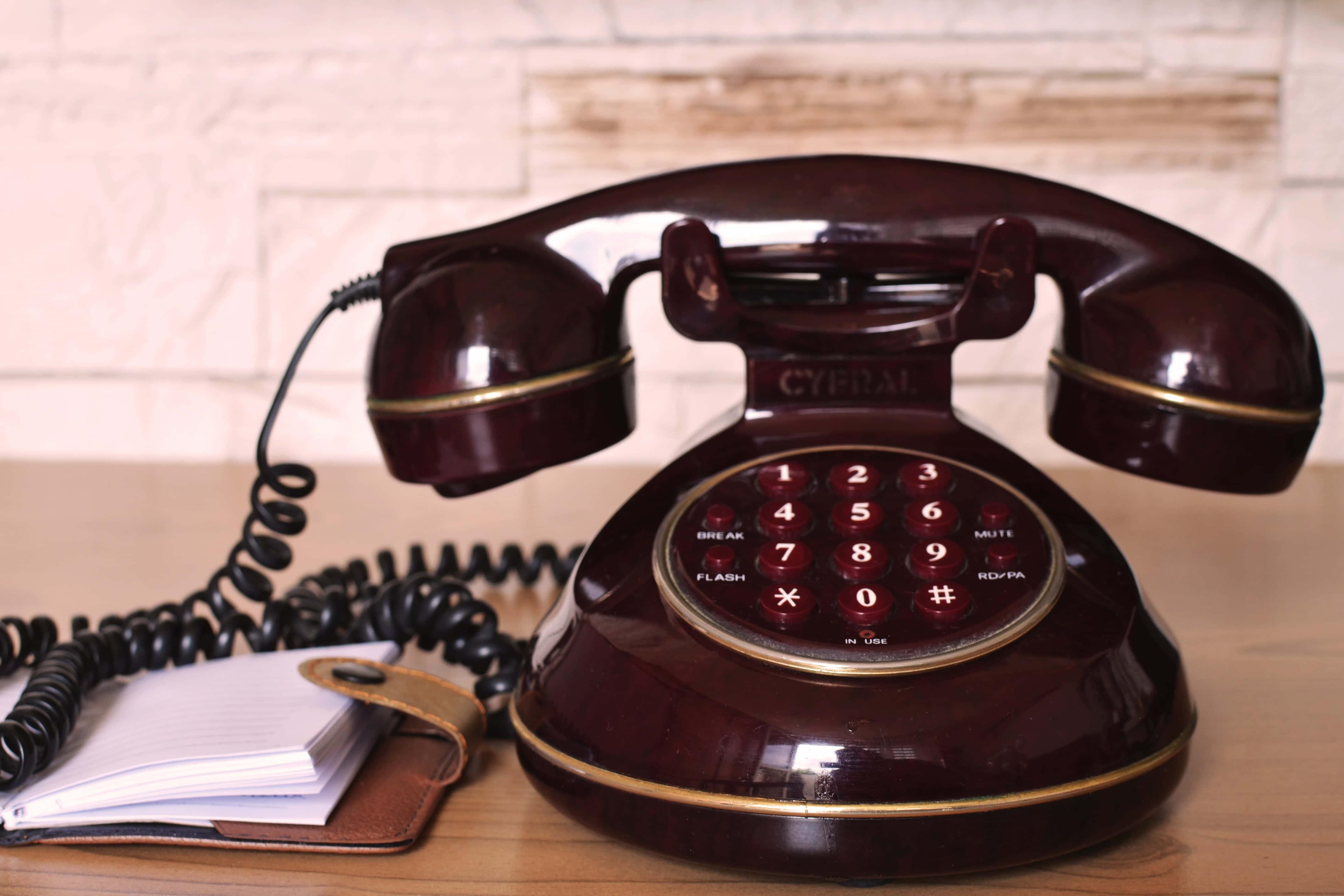 vintage rotary phone, glossy burgundy, gold trim, 4K Desktop Wallpaper