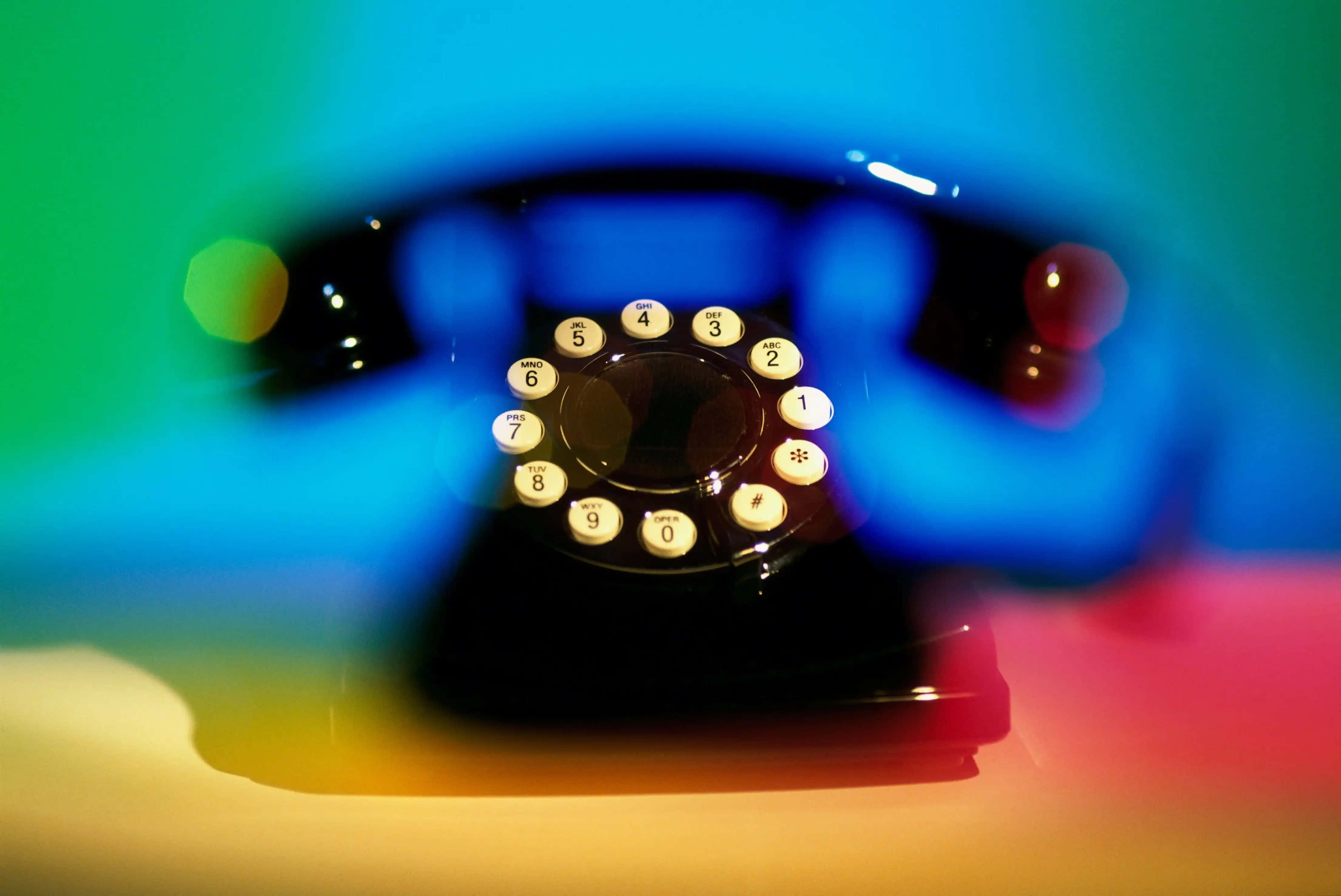 vintage black rotary phone, white buttons, vibrant rainbow lighting, 4K Desktop Wallpaper