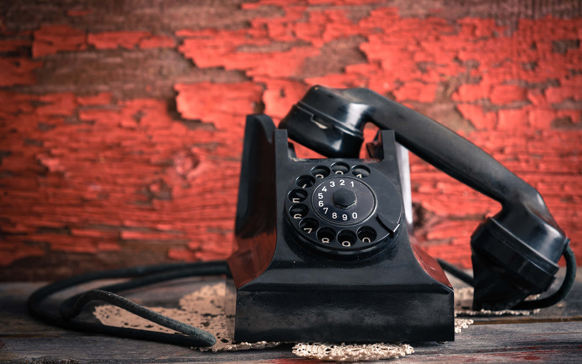 vintage black rotary phone, red background, weathered wooden surface, Full HD Desktop Wallpaper