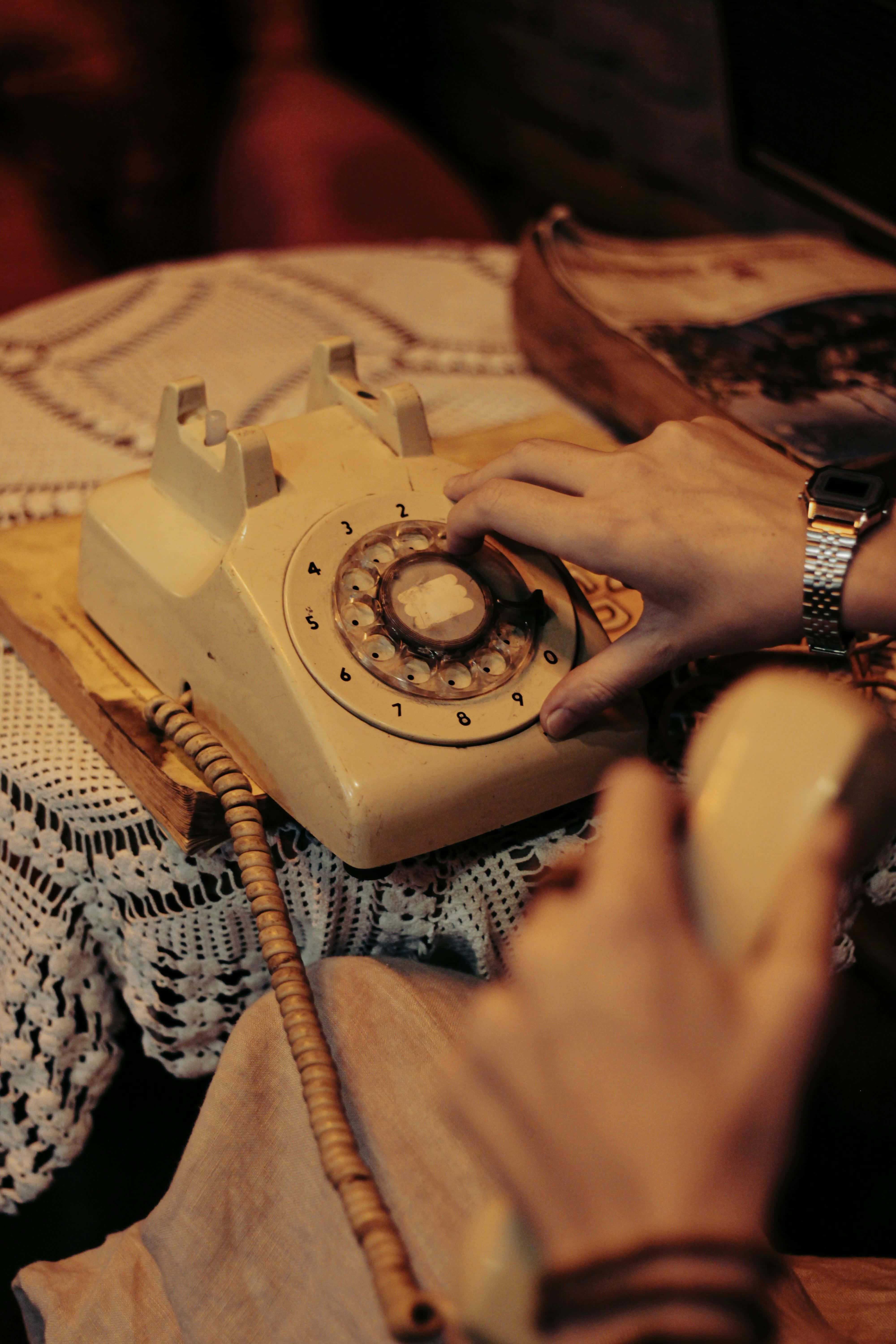 vintage cream rotary phone, lace tablecloth, warm golden light, 5K Phone Wallpaper