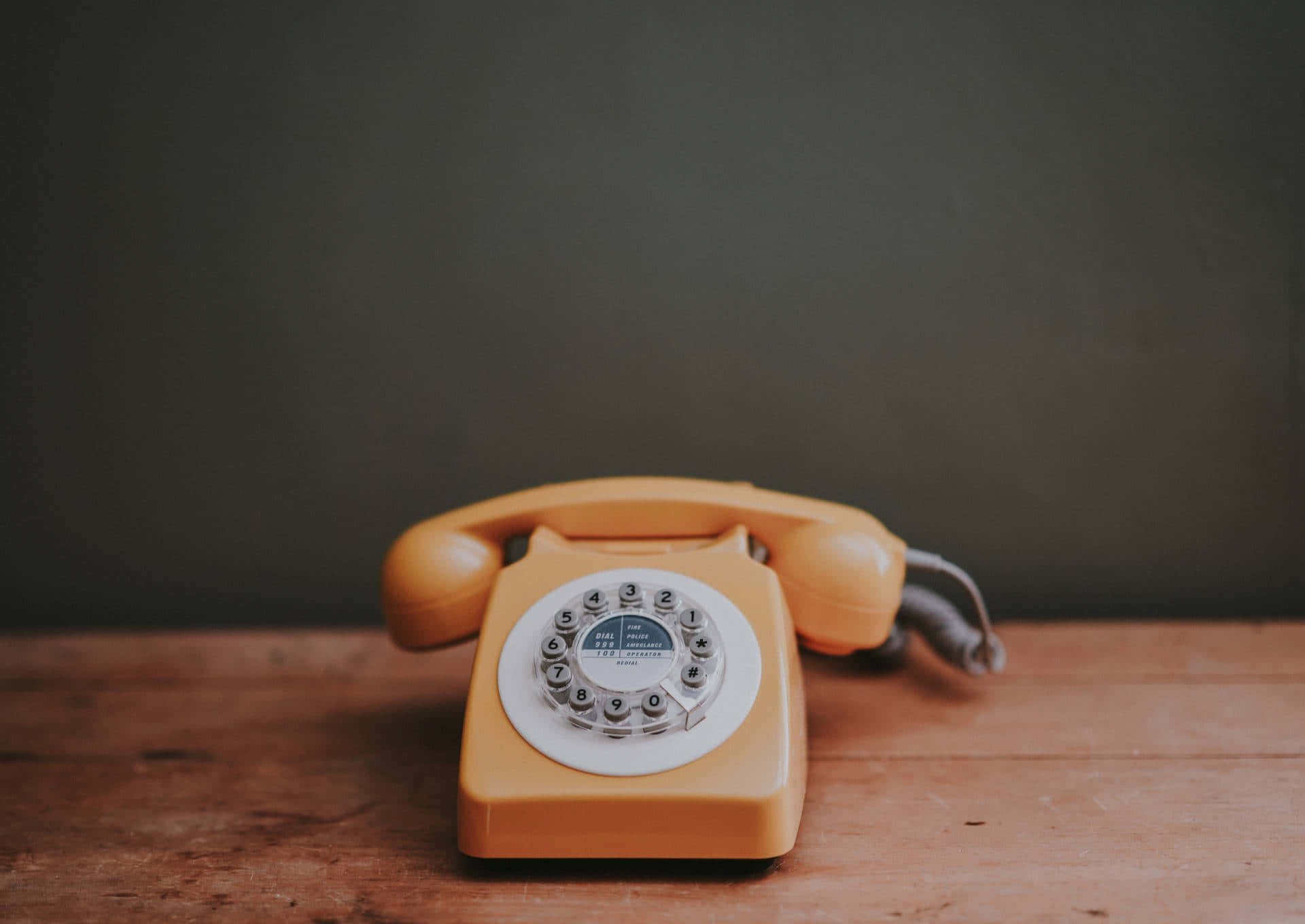 vintage yellow rotary phone, rustic wooden table, muted gray wall, Full HD Desktop Wallpaper