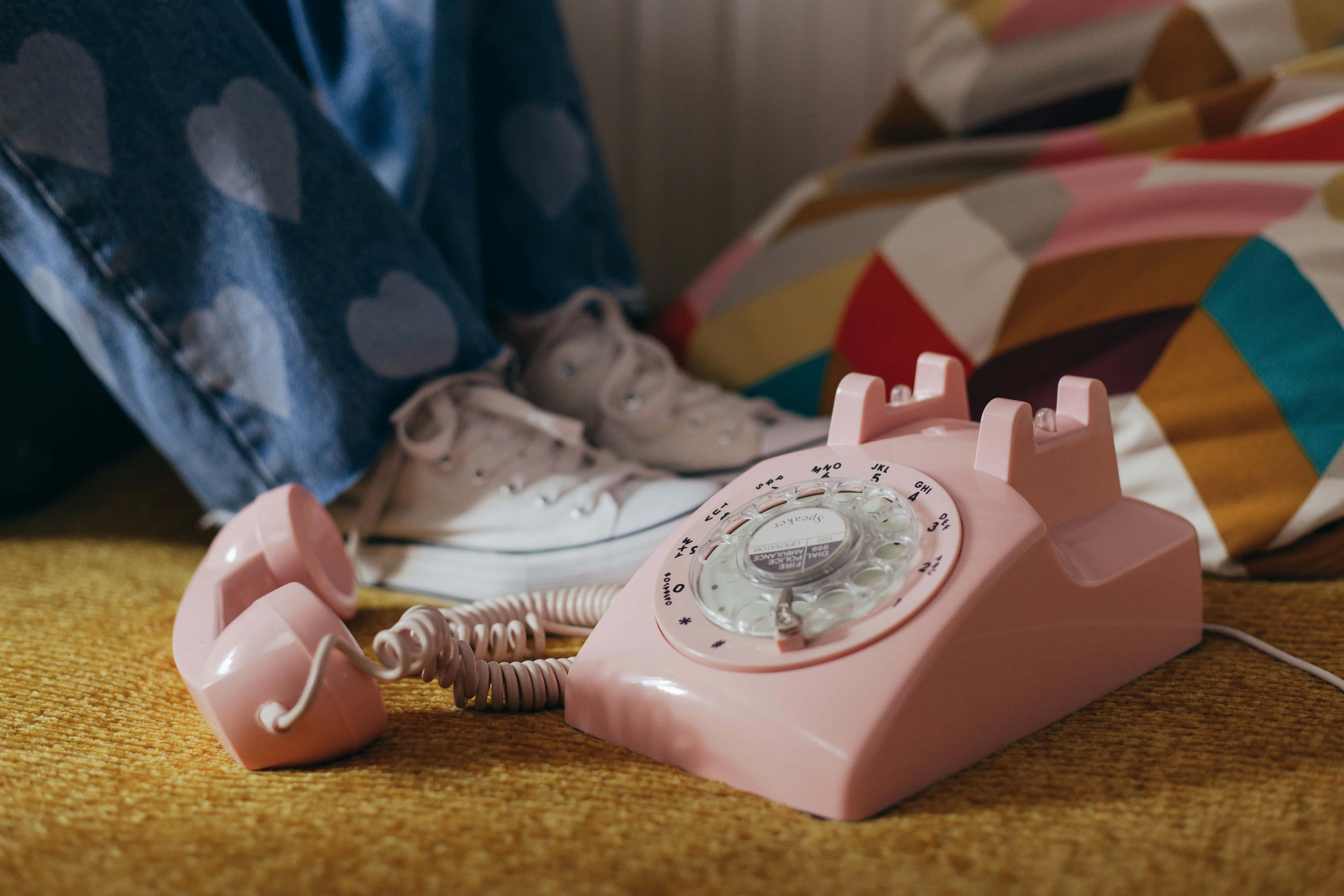 vintage pink rotary phone, yellow rug, heart-patterned jeans, 5K Desktop Wallpaper