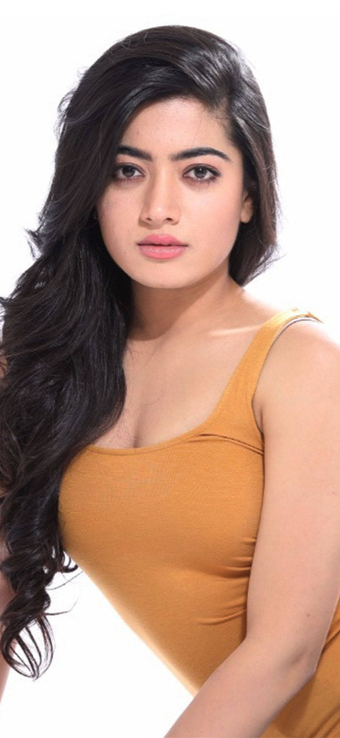 long dark wavy hair, mustard yellow tank top, plain white background, Full HD Phone Wallpaper