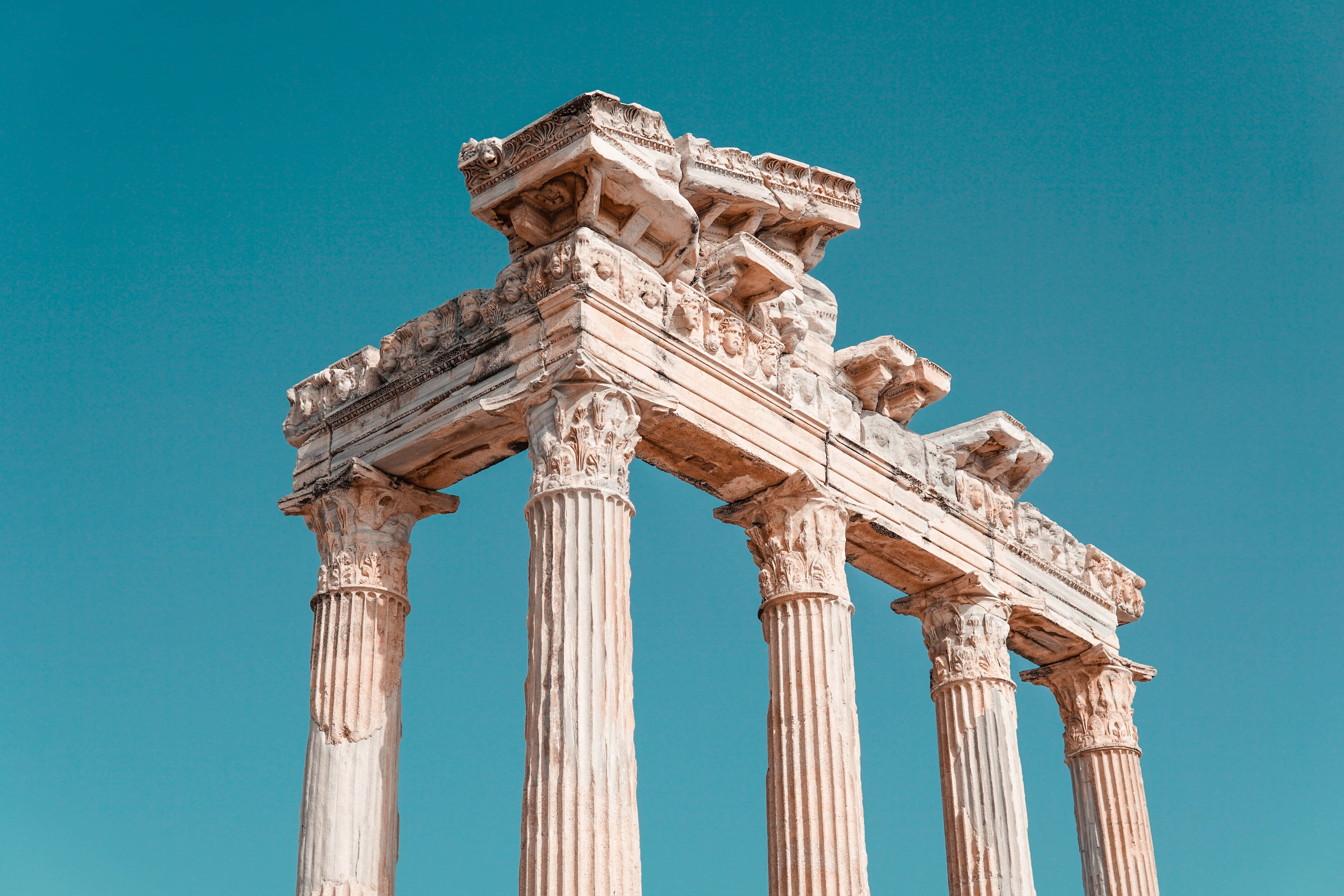Temple Of Apollo, ancient stone temple columns, vibrant turquoise sky, 5K Desktop Wallpaper