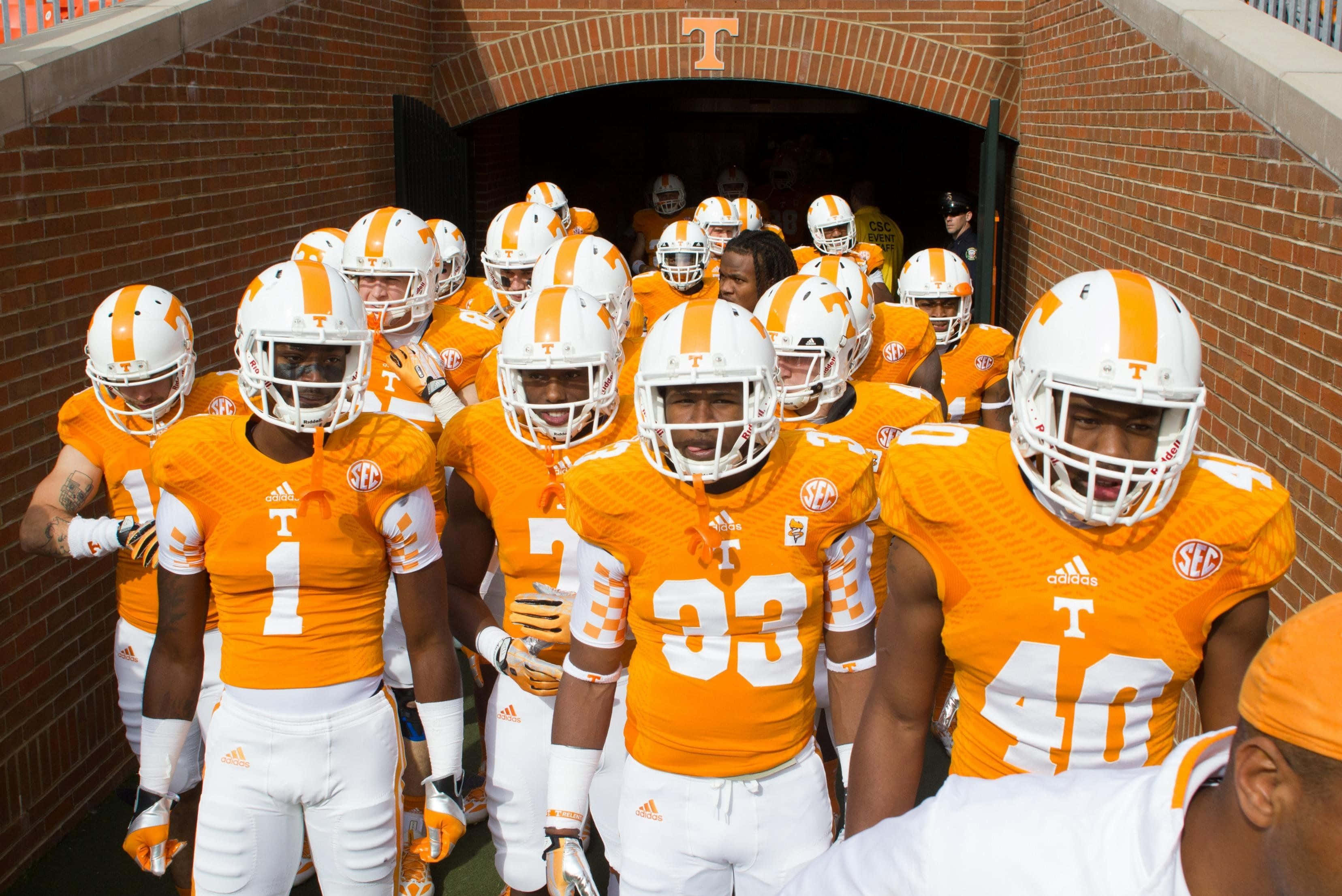 Tennessee Volunteers, orange and white uniforms, brick tunnel, 2K Desktop Wallpaper