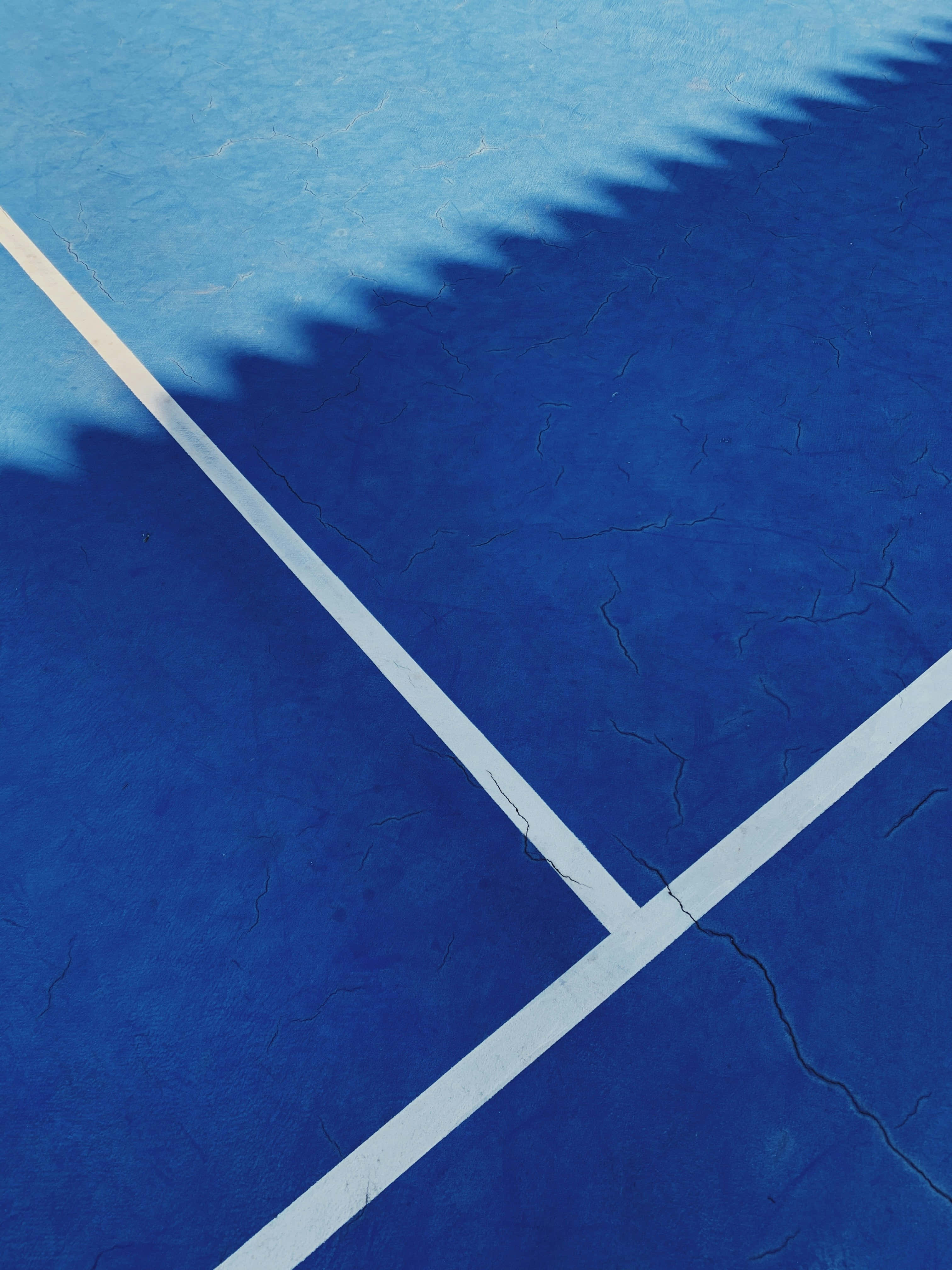 blue tennis court, white lines, jagged shadow, 4K Phone Wallpaper