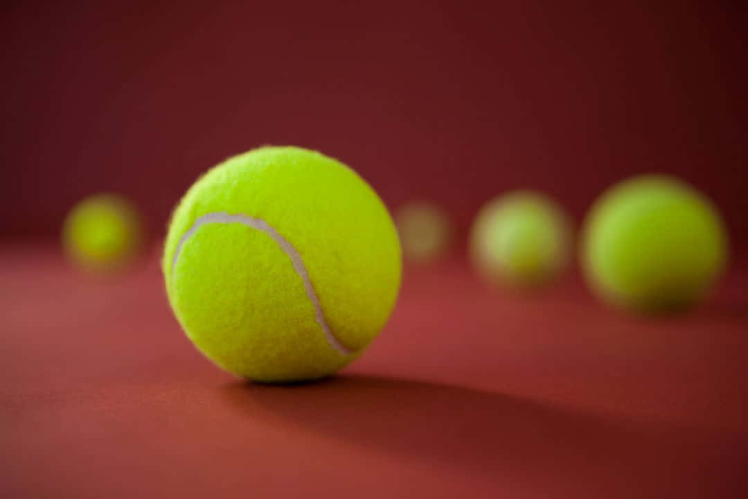tennis ball, bright yellow, deep red surface, SD Desktop Wallpaper