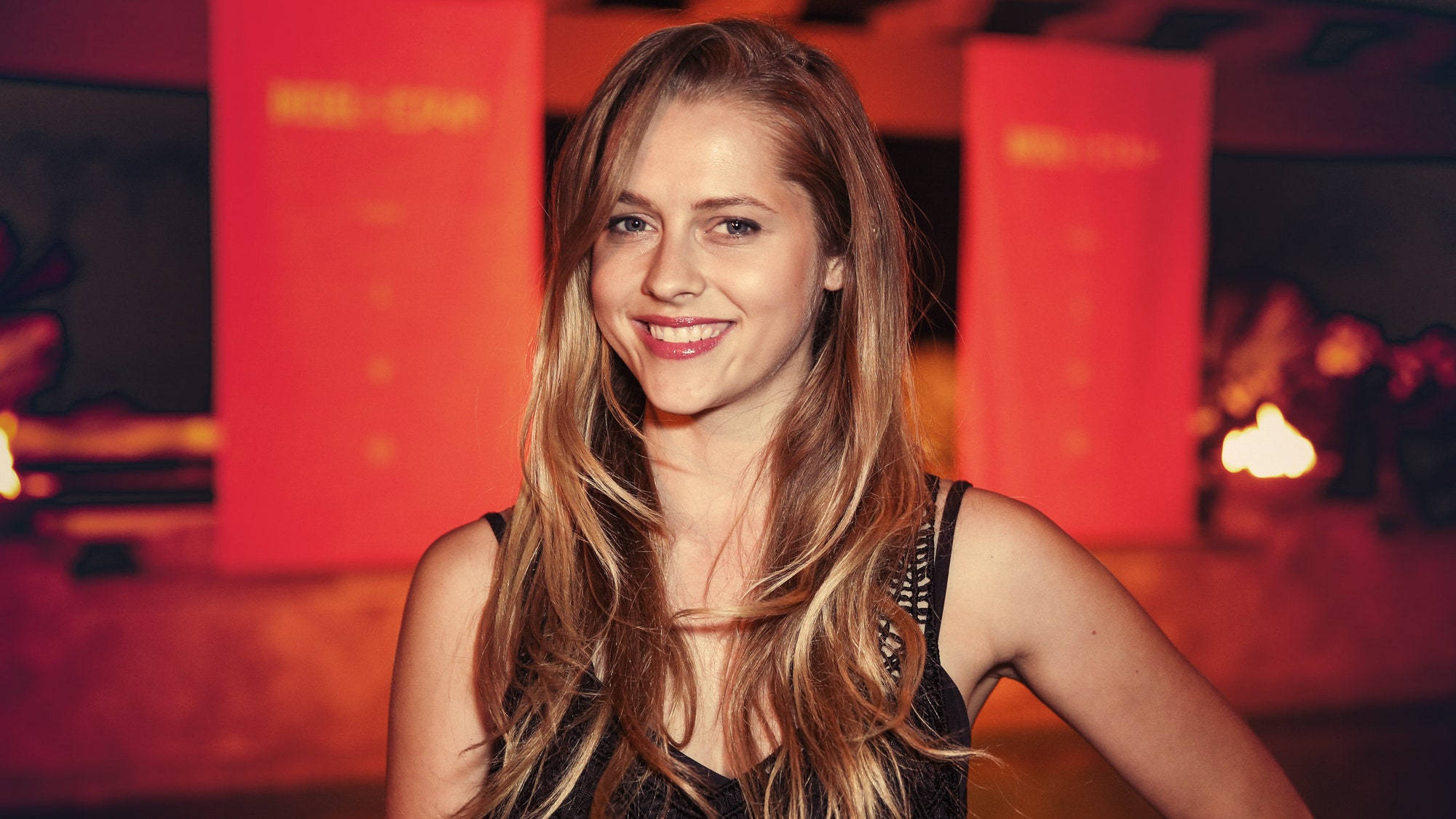 Teresa Palmer, long blonde hair, warmly lit red-hued indoor setting, Full HD Desktop Wallpaper