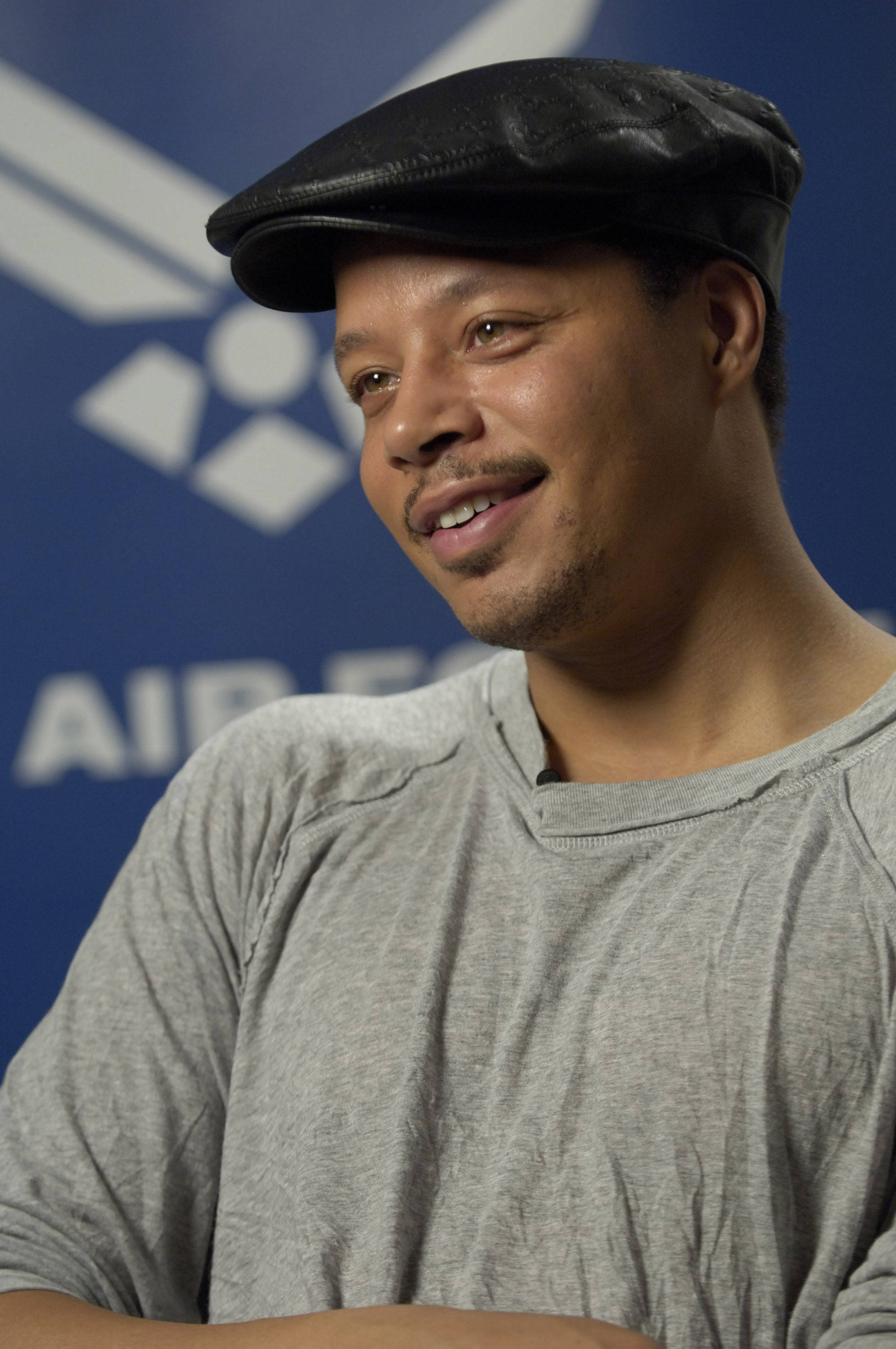 Terrence Howard, black cap, blue Air Force backdrop, 2K Phone Wallpaper