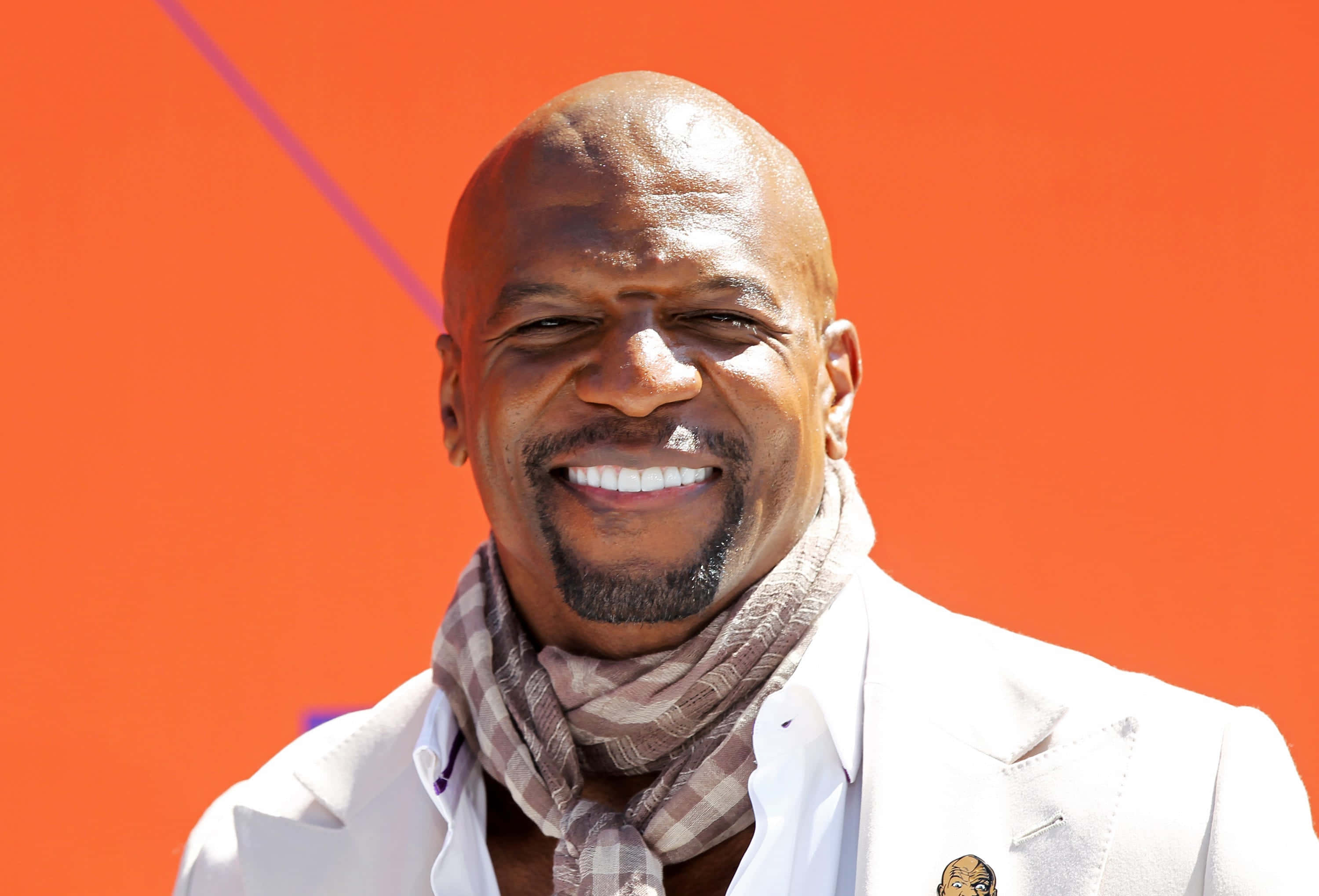 Terry Crews, white suit, vibrant orange background, 2K Desktop Wallpaper
