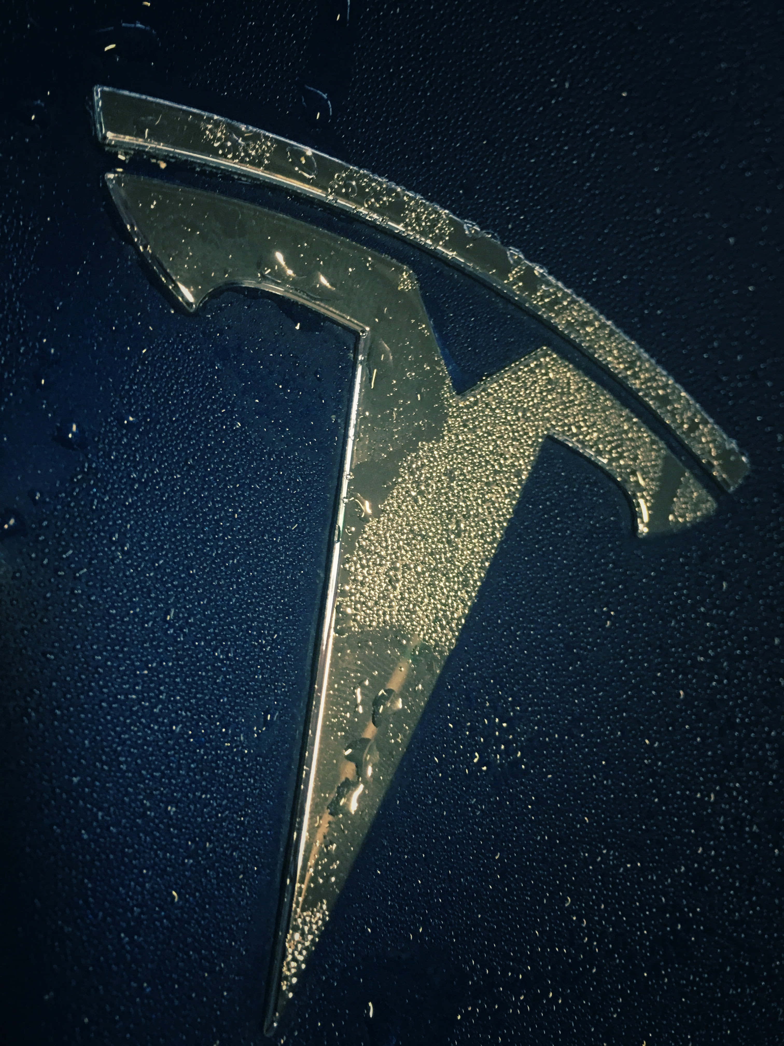 Tesla logo, black background, raindrops, 4K Phone Wallpaper