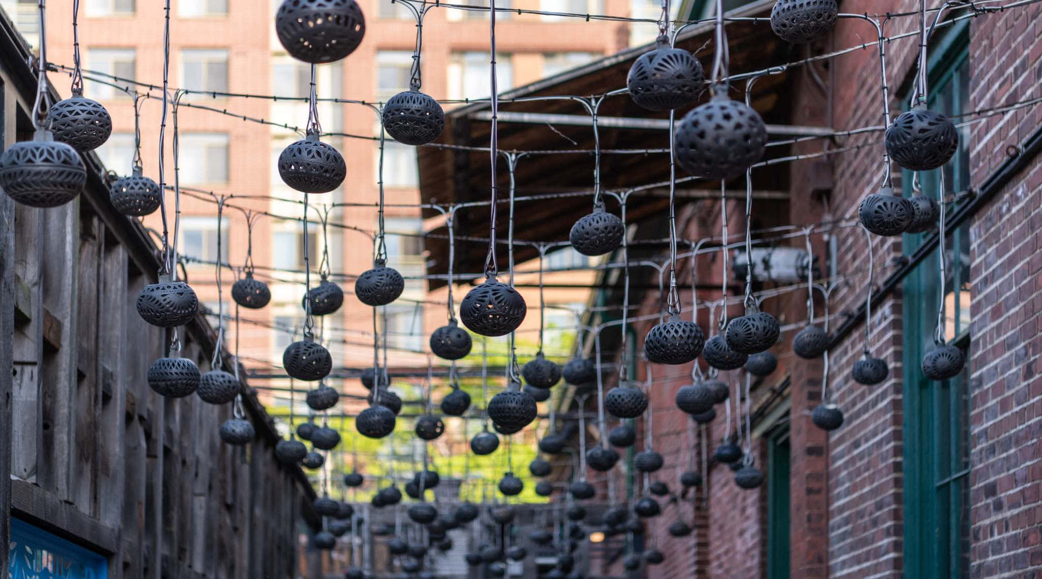 Distillery District, dark perforated metal lanterns, brick buildings, Full HD Desktop Wallpaper