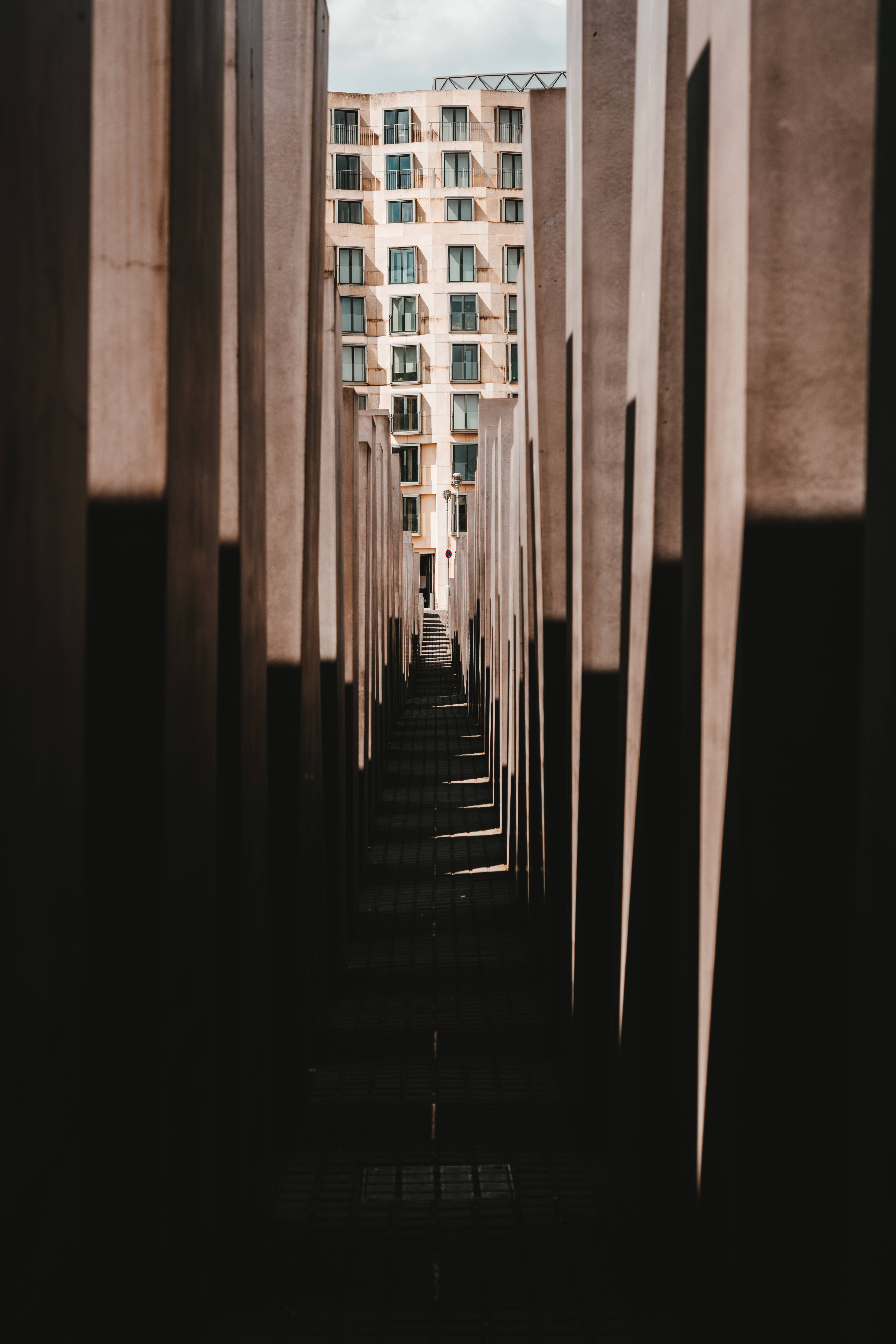 end building, concrete passage, tall concrete pillars, 8K Phone Wallpaper