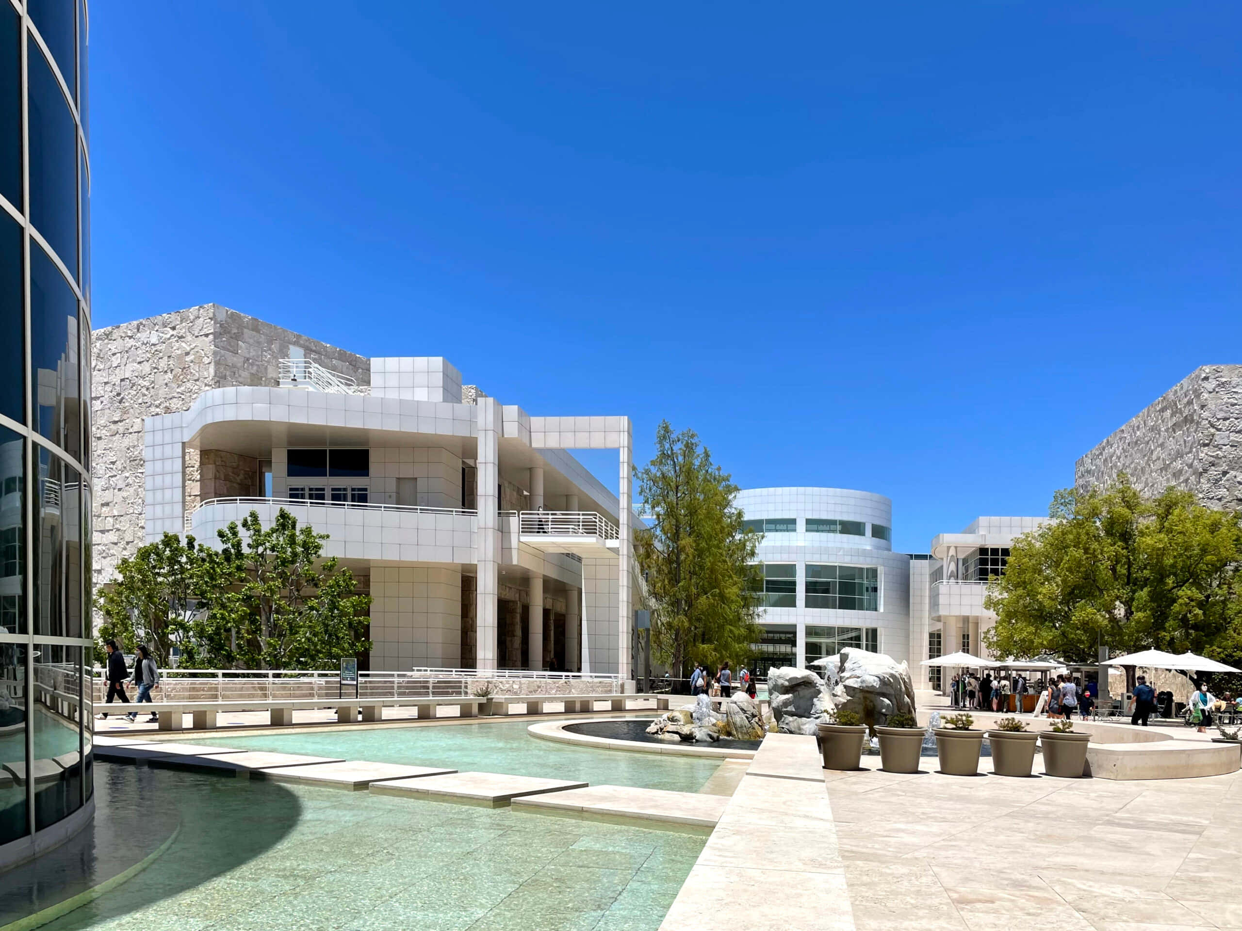 Getty Center, sunny courtyard view, glass and stone buildings, 2K Desktop Wallpaper