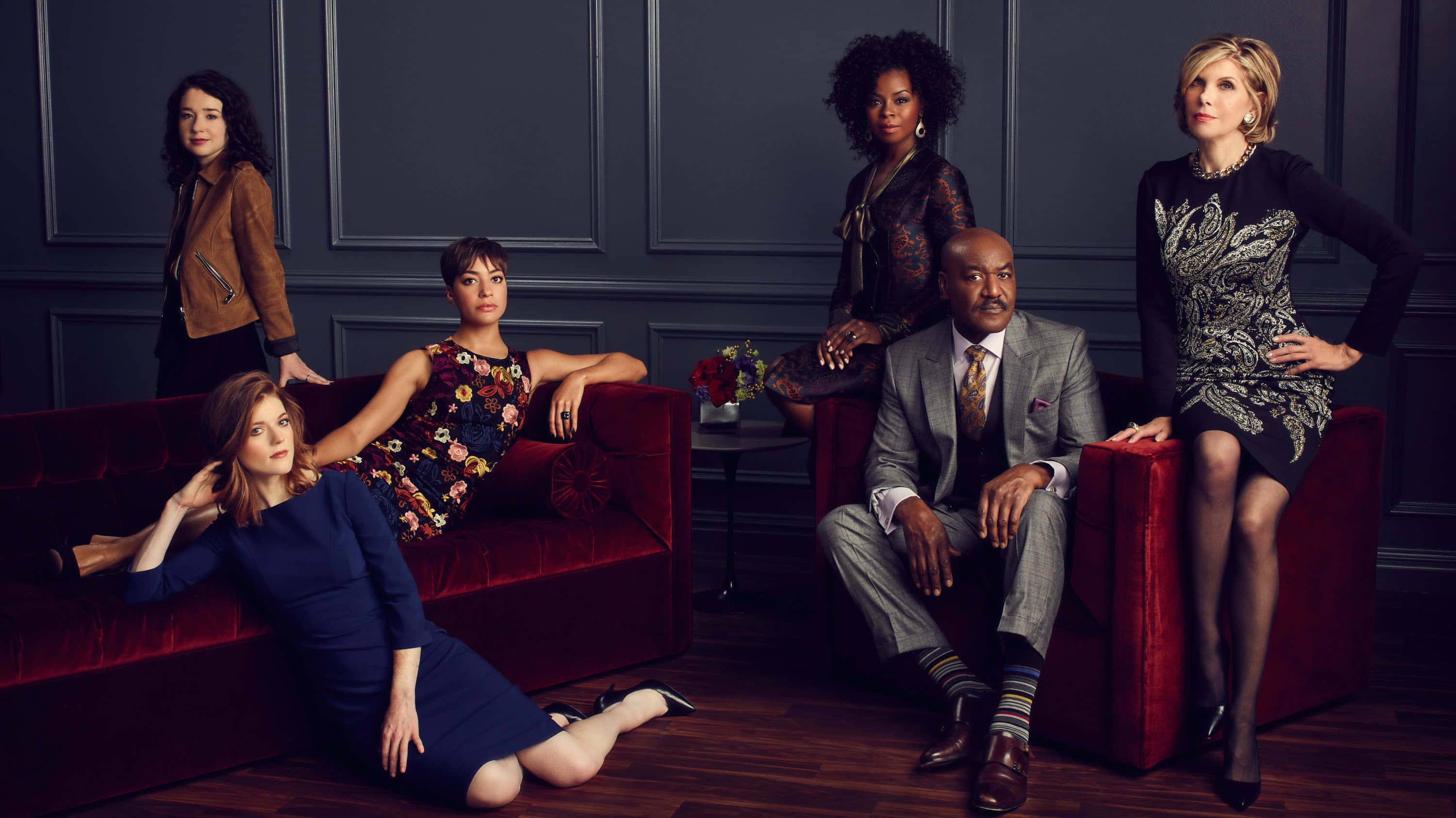 The Good Fight, red velvet sofa, dark paneled wall, 2K Desktop Wallpaper