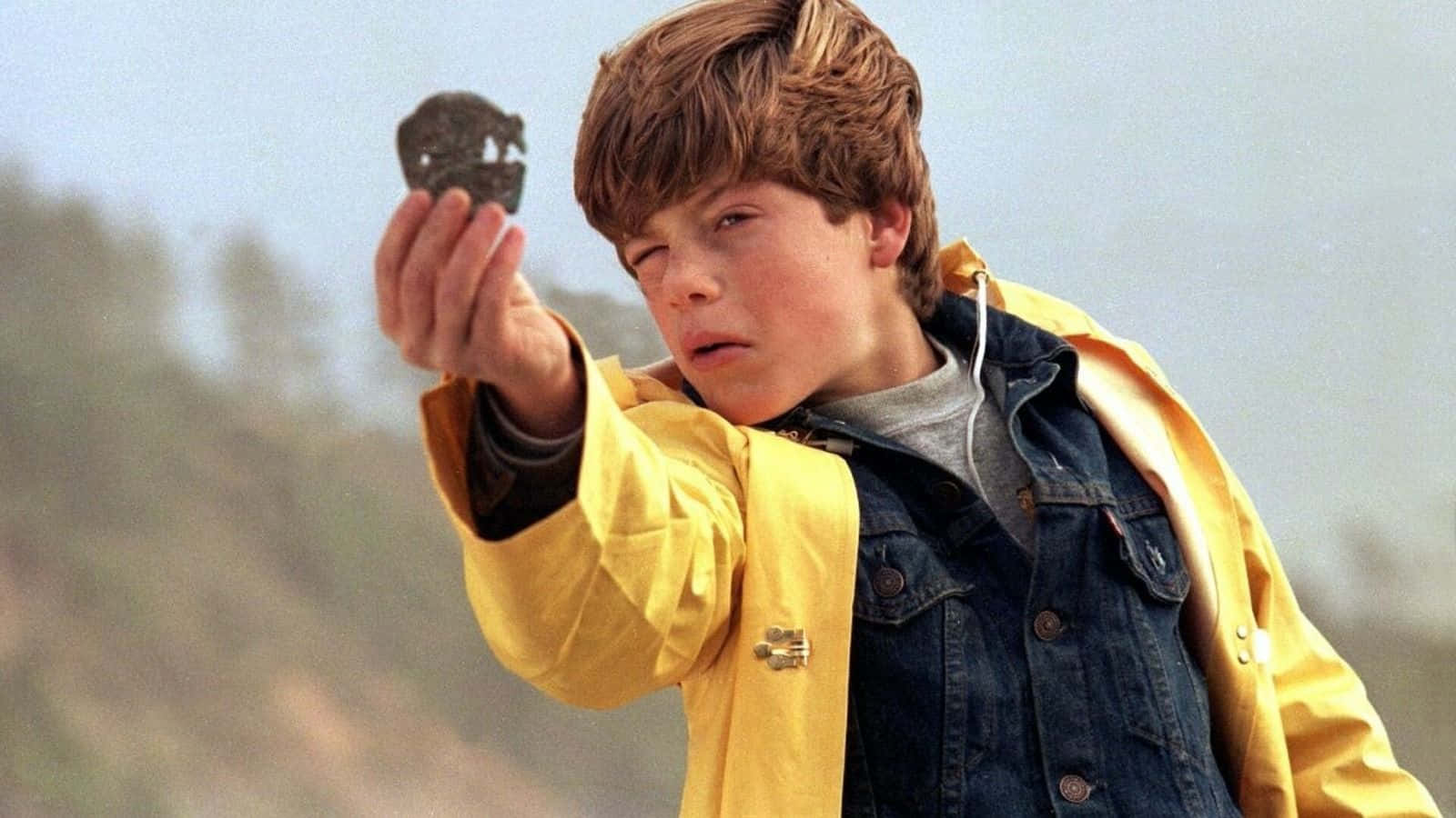 Goonies, yellow raincoat, dark skull-shaped rock, HD Desktop Wallpaper