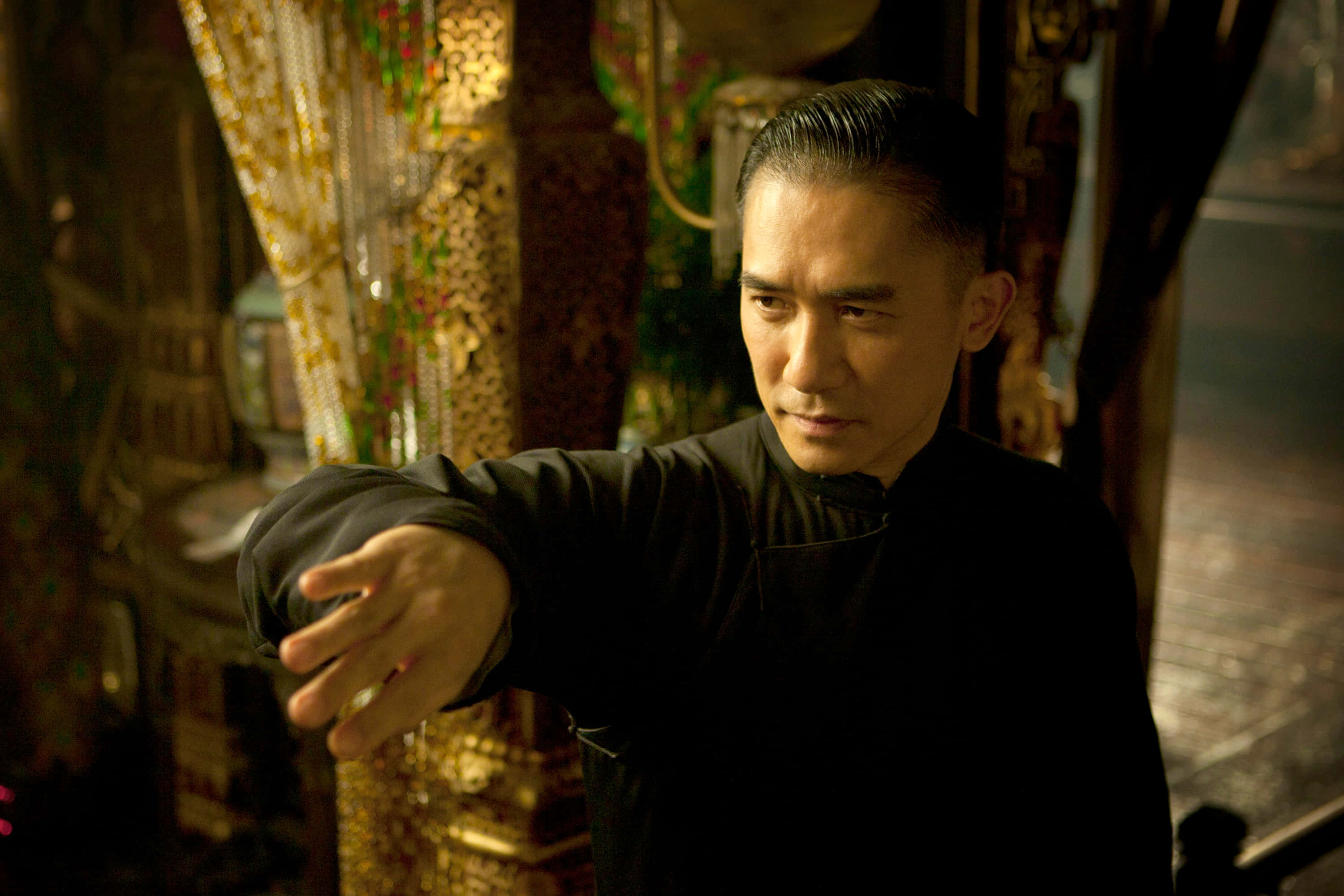 The Grandmaster, black shirt, dimly lit ornate room, 2K Desktop Wallpaper