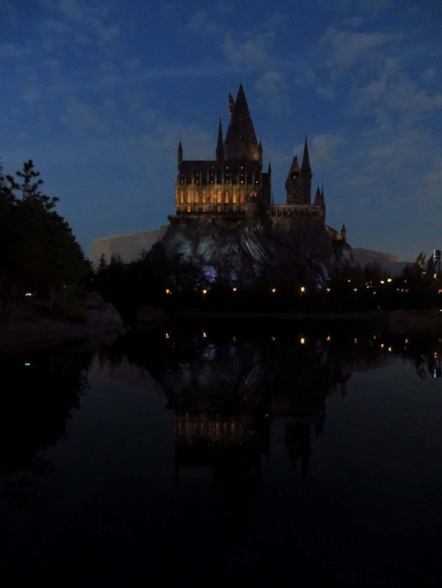 The Hogwarts Lake, castle, glowing windows, SD Phone Wallpaper