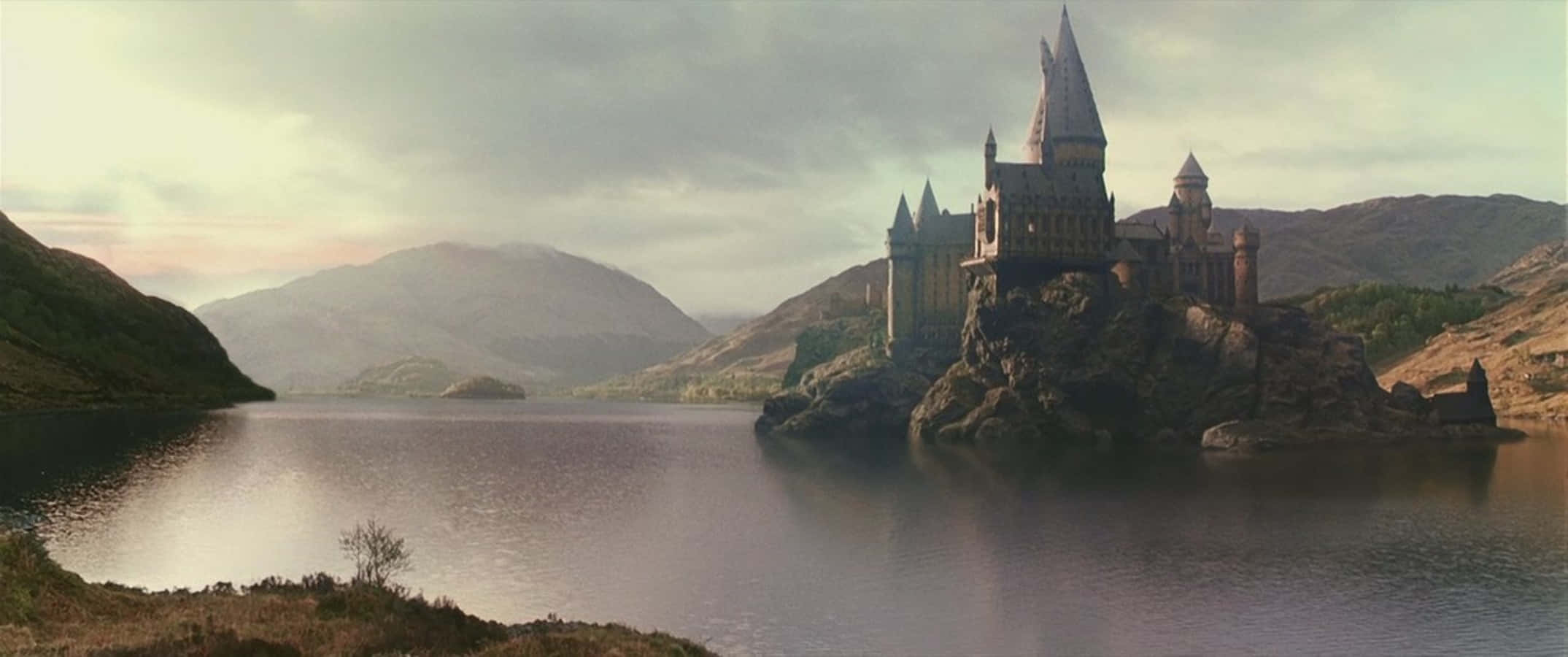 Hogwarts Lake, castle with spires, rocky island, Full HD Desktop Wallpaper